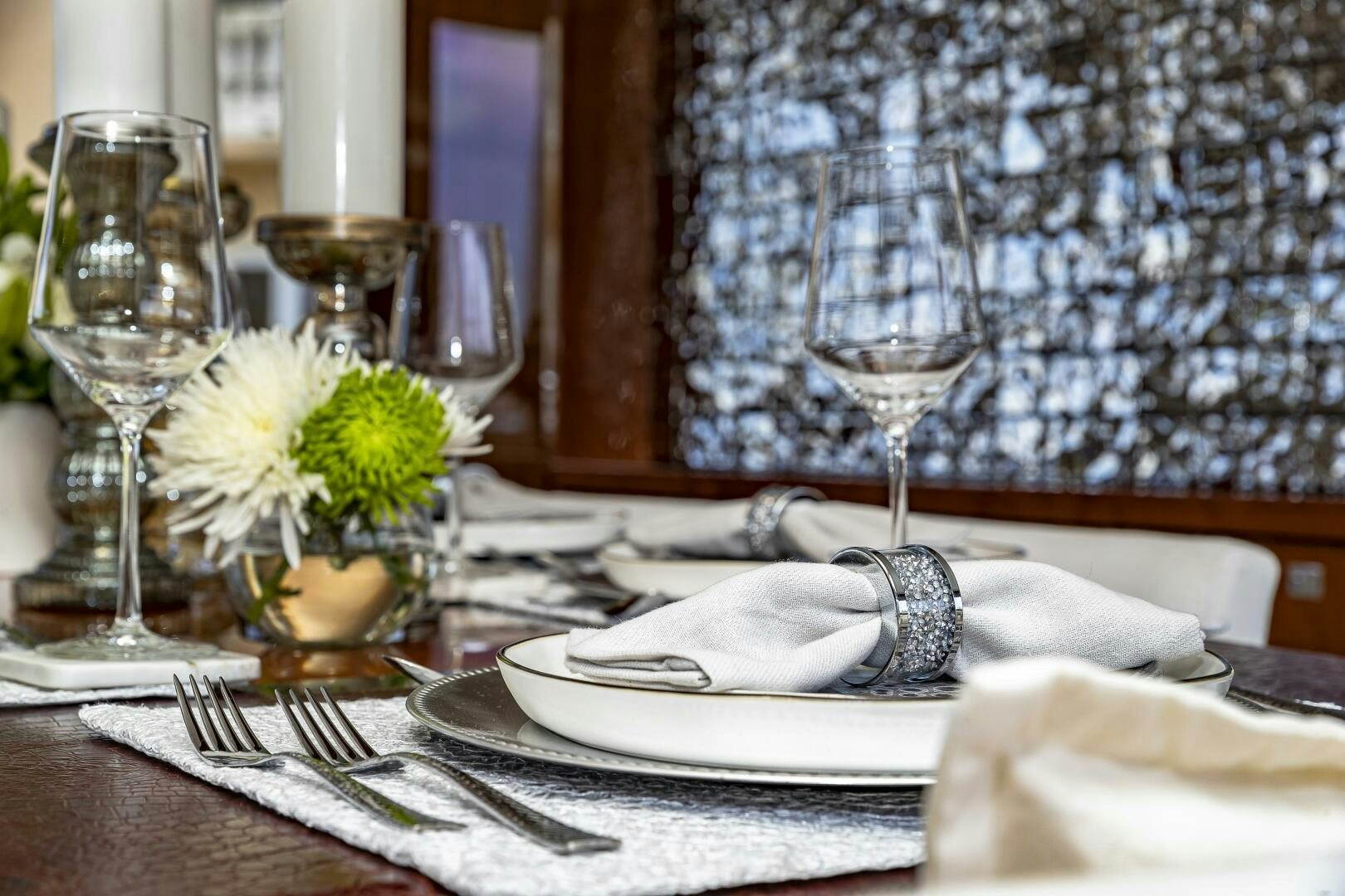 a table with a plate of food and glasses on it aboard BEACHFRONT II Yacht for Sale