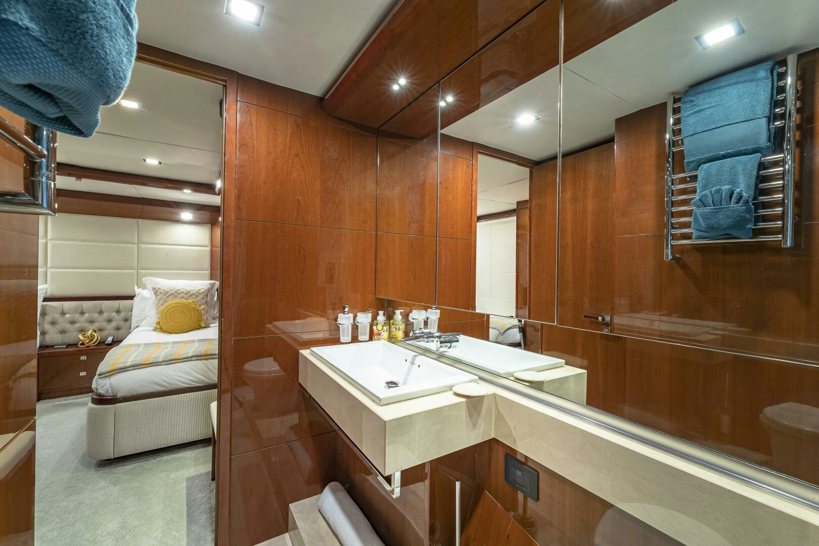 a bathroom with a sink and a bed aboard BEACHFRONT II Yacht for Sale