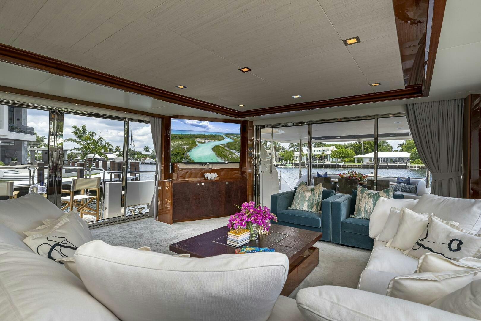 a living room with a large glass window aboard BEACHFRONT II Yacht for Sale