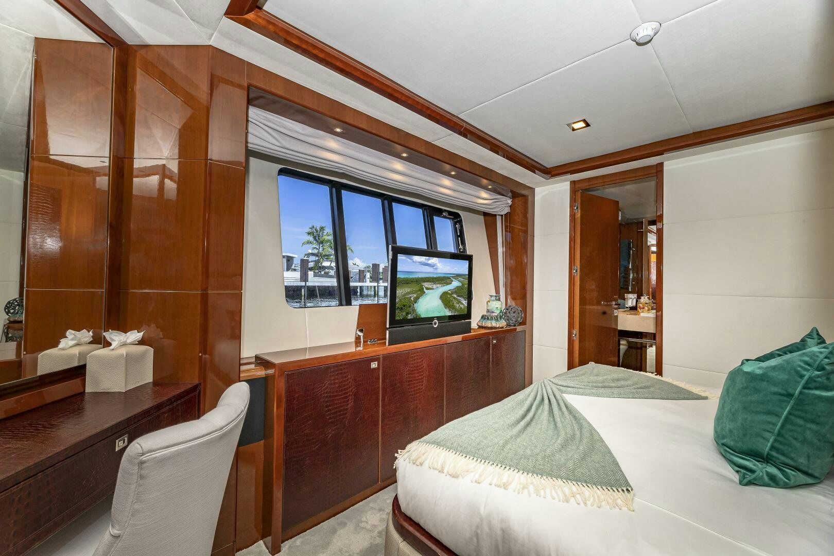 a bedroom with a bed and a television aboard BEACHFRONT II Yacht for Sale