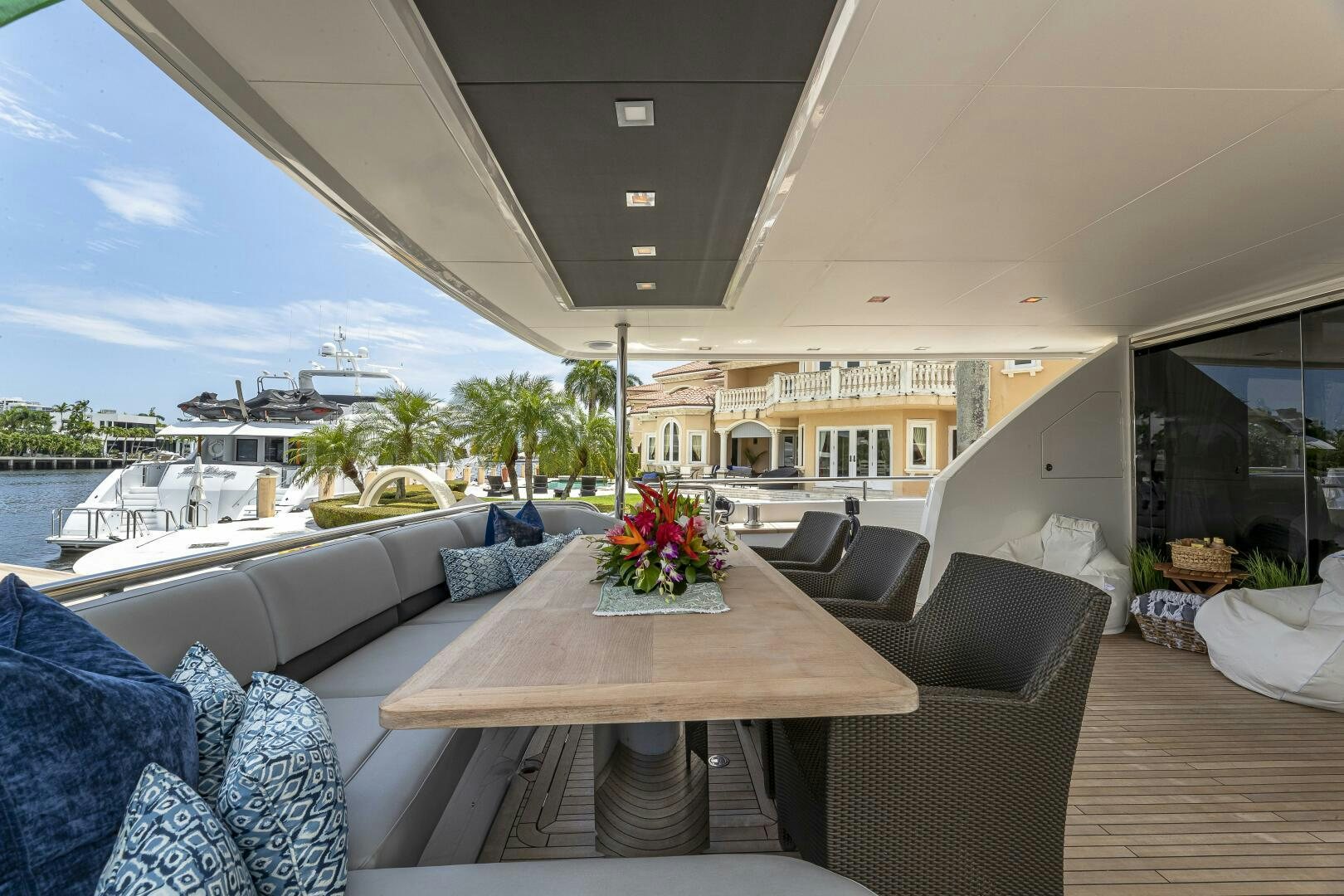 a table and chairs on a deck aboard BEACHFRONT II Yacht for Sale
