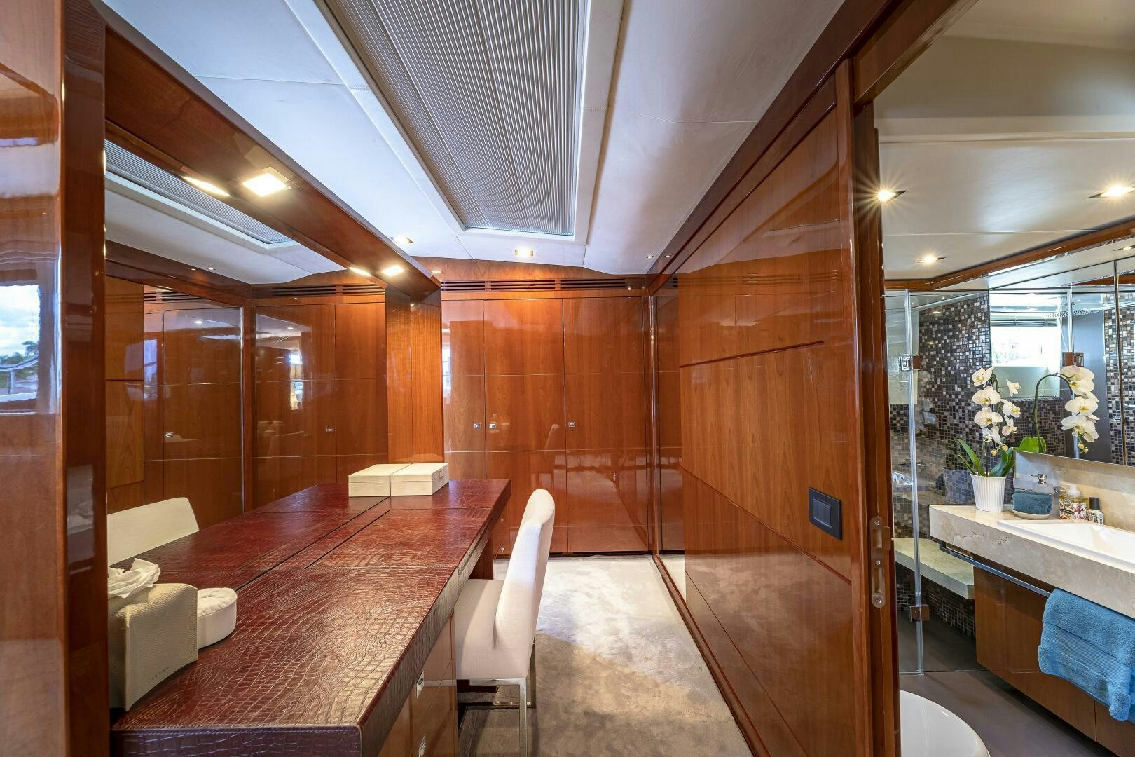 a large room with a long wood table and chairs aboard BEACHFRONT II Yacht for Sale