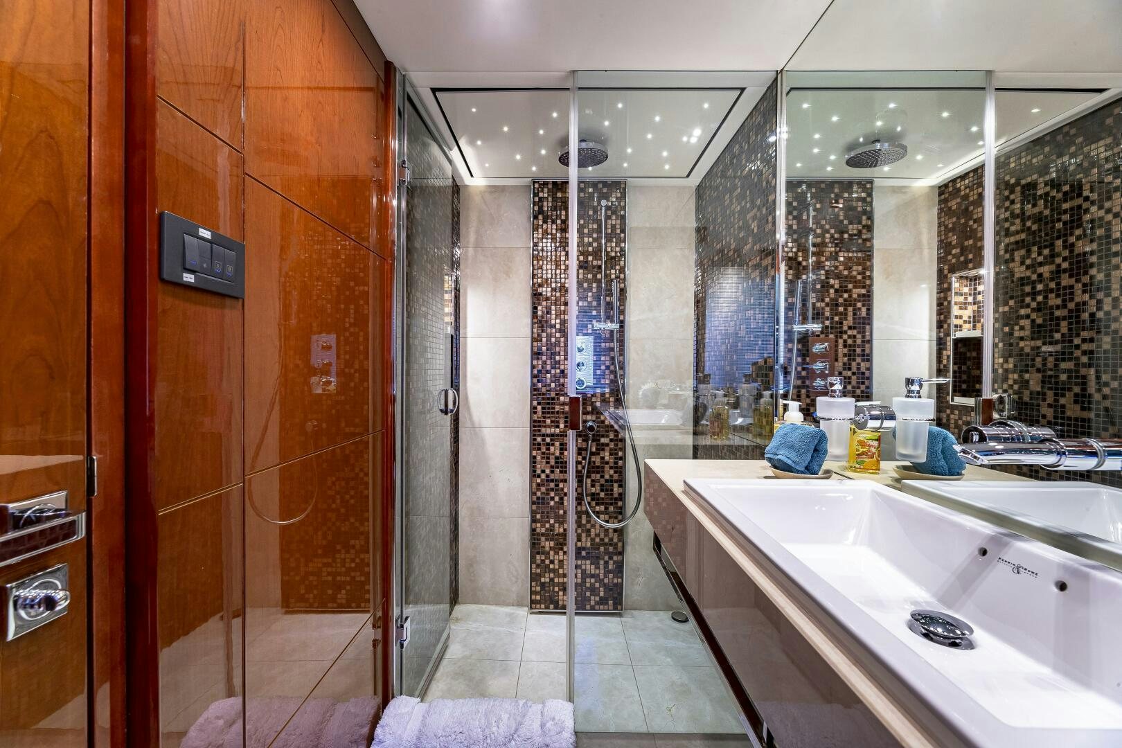 a bathroom with a shower and sink aboard BEACHFRONT II Yacht for Sale