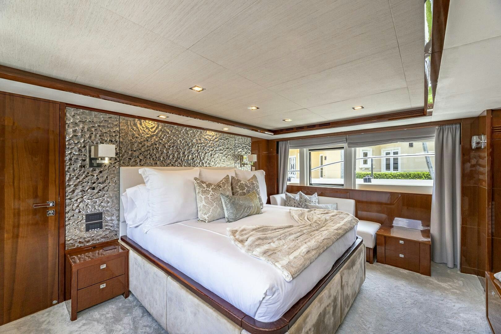 a bedroom with a bed and a dresser aboard BEACHFRONT II Yacht for Sale