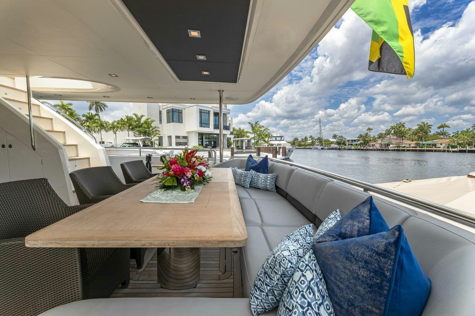 a table and chairs on a deck aboard BEACHFRONT II Yacht for Sale