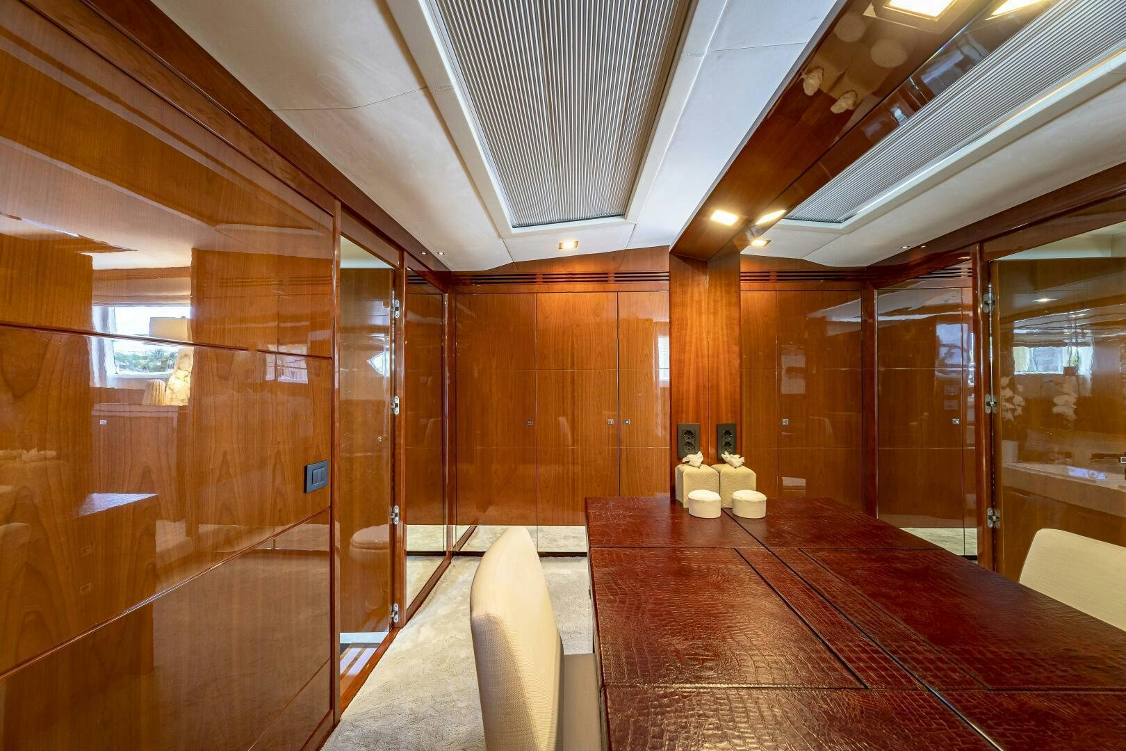 a room with a wood floor and a large mirror aboard BEACHFRONT II Yacht for Sale