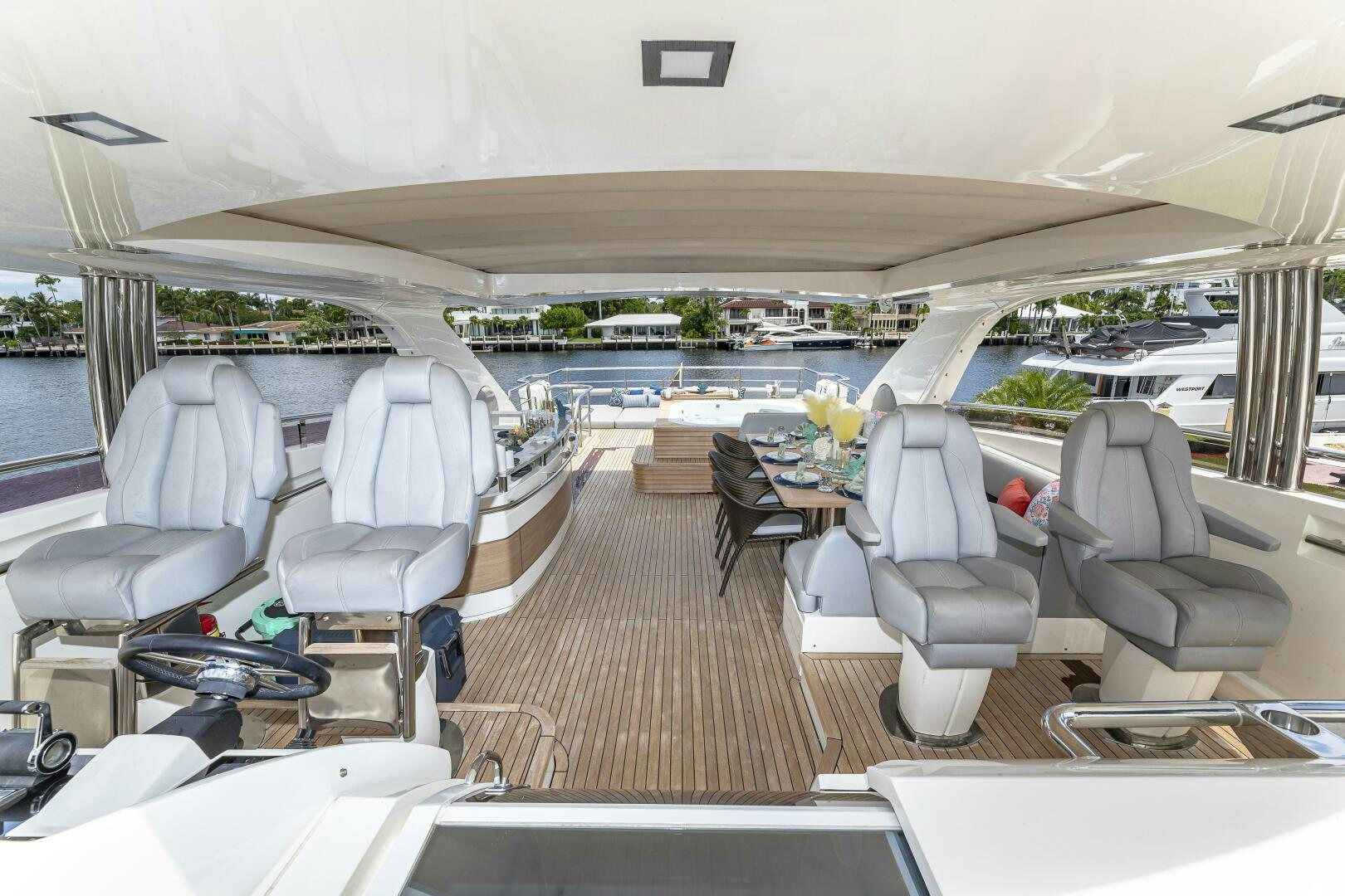 a boat with chairs and tables aboard BEACHFRONT II Yacht for Sale