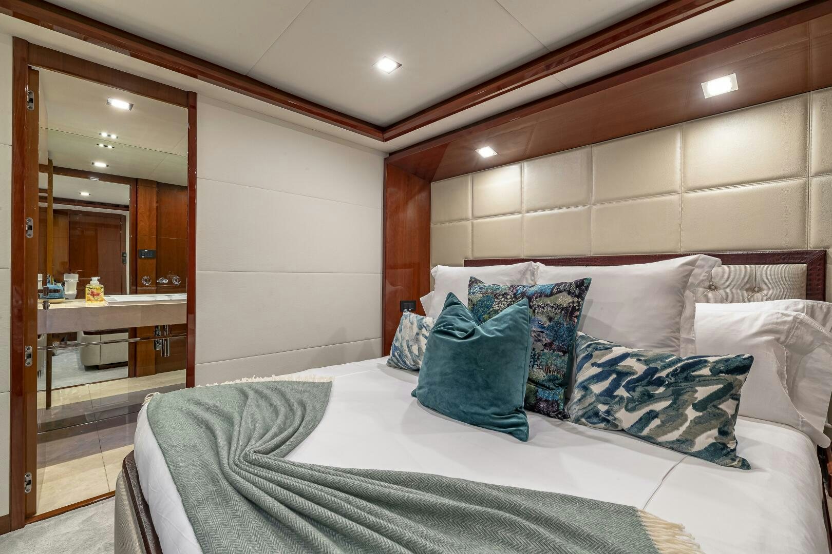 a bed with pillows on it aboard BEACHFRONT II Yacht for Sale