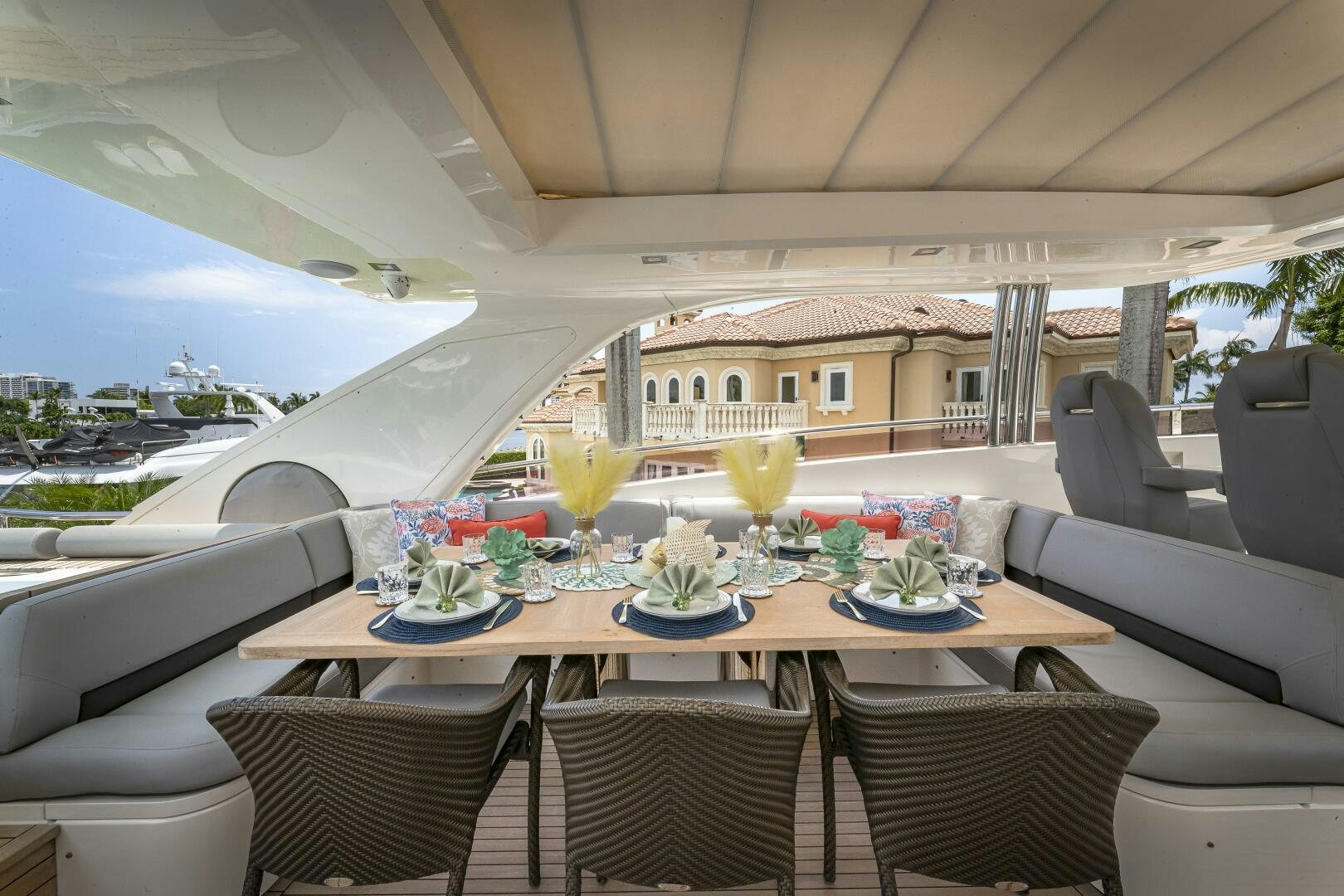 a table with chairs and a view of a city aboard BEACHFRONT II Yacht for Sale