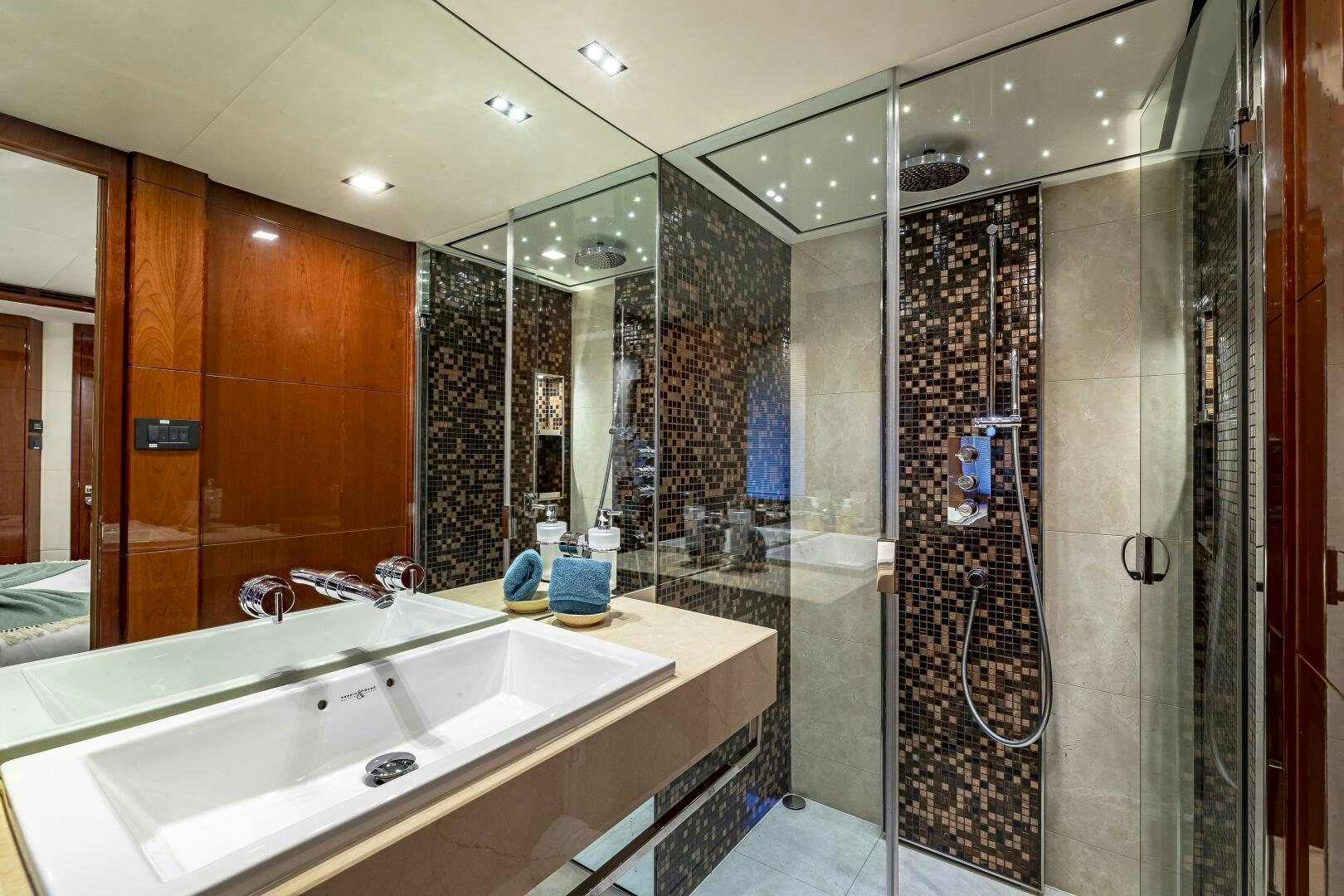 a bathroom with a sink and a shower unit aboard BEACHFRONT II Yacht for Sale