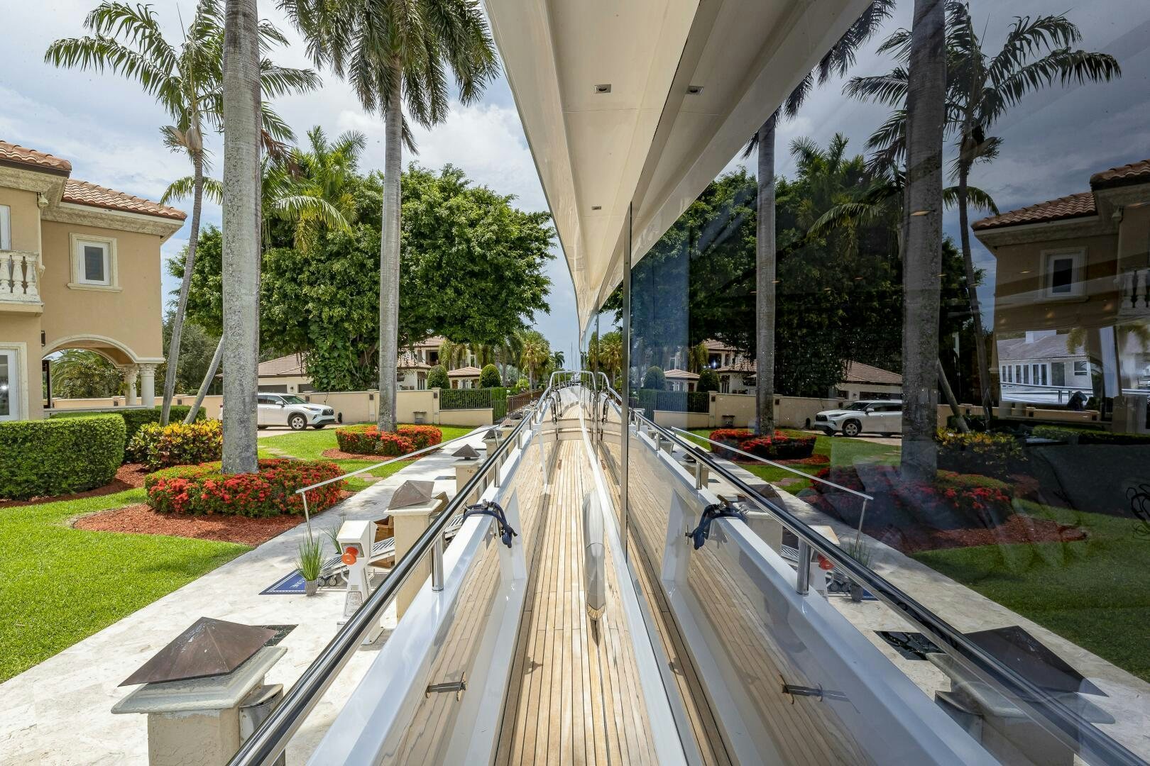a patio with a pool and trees aboard BEACHFRONT II Yacht for Sale