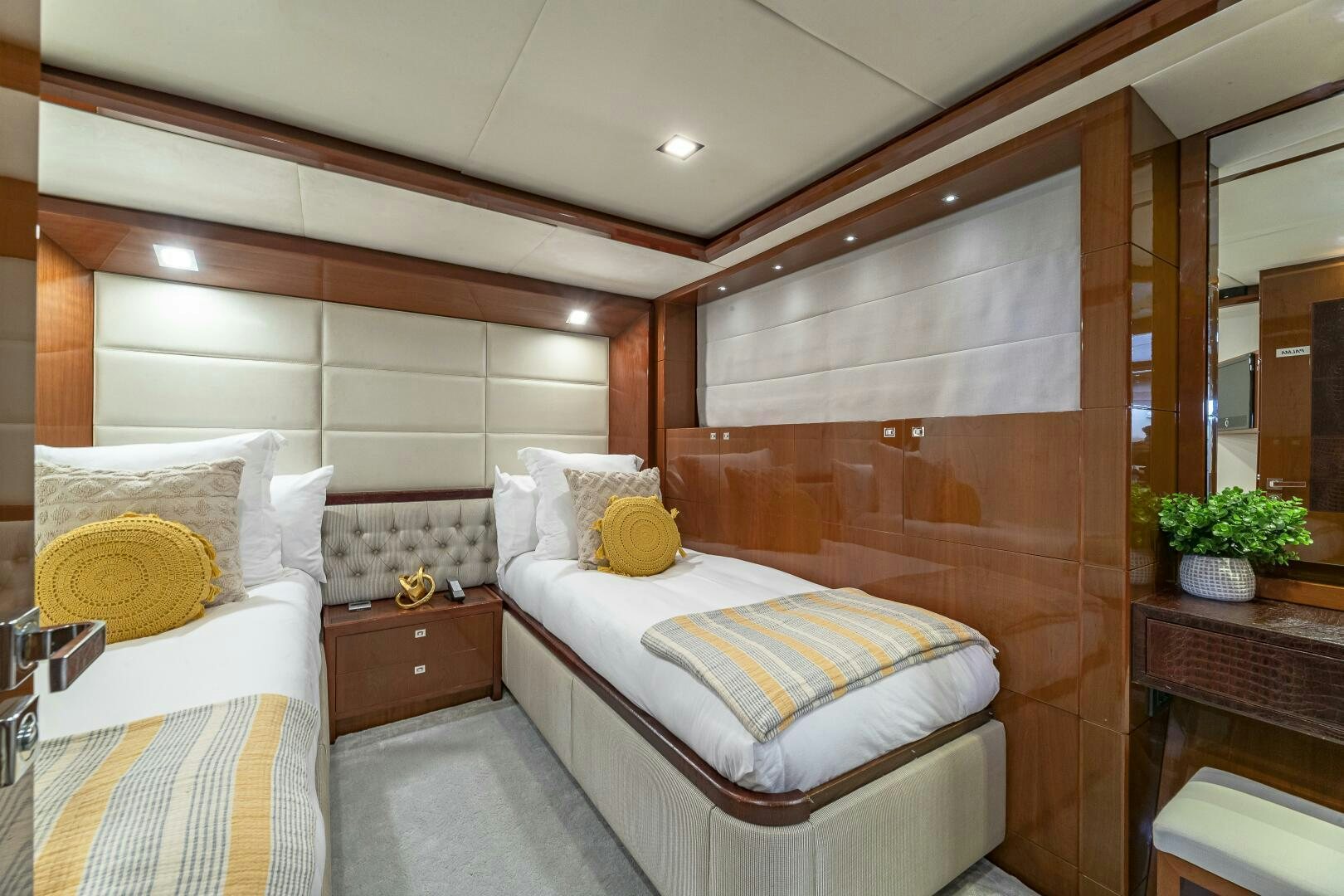 a room with a bed and a mirror aboard BEACHFRONT II Yacht for Sale