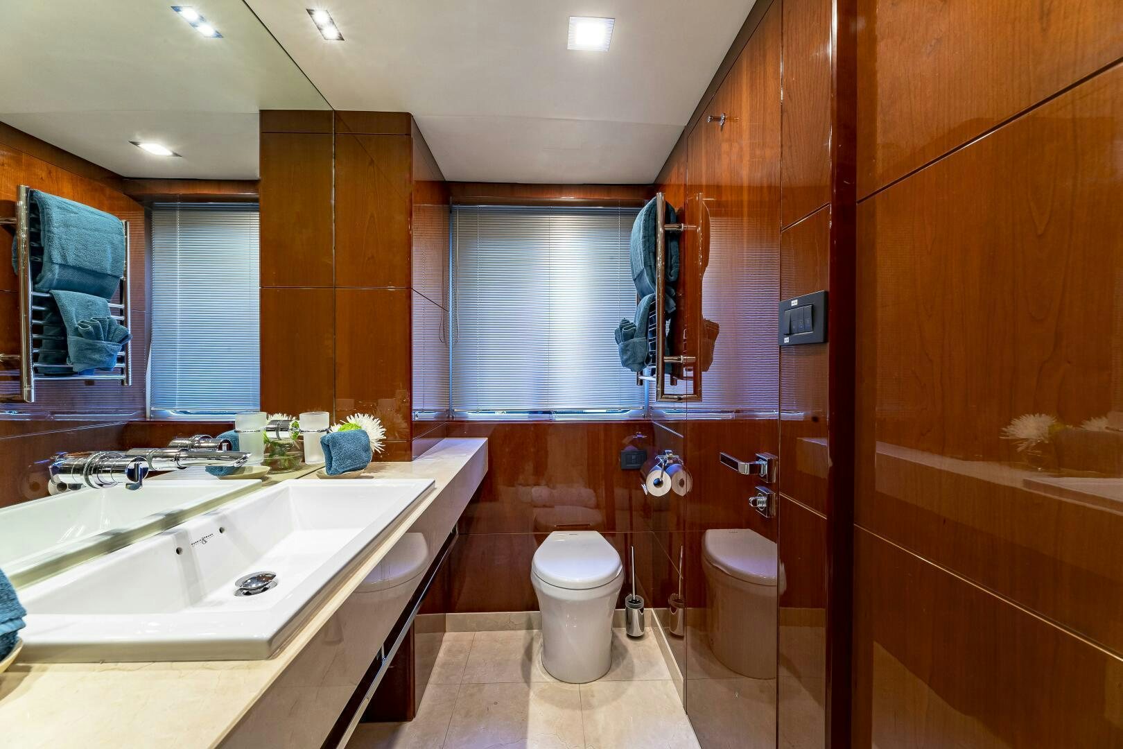 a bathroom with a sink toilet and a mirror aboard BEACHFRONT II Yacht for Sale