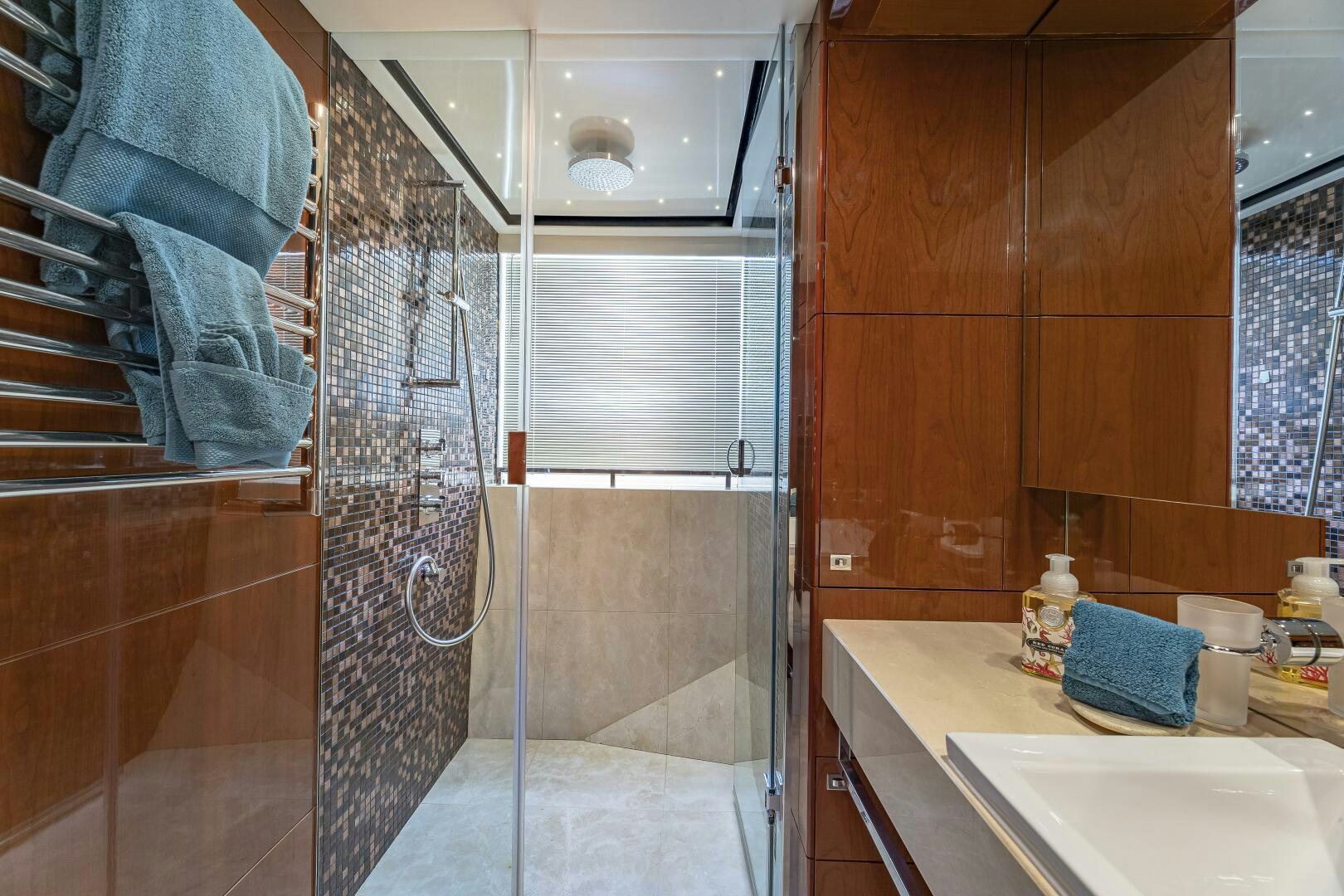 a bathroom with a shower curtain aboard BEACHFRONT II Yacht for Sale