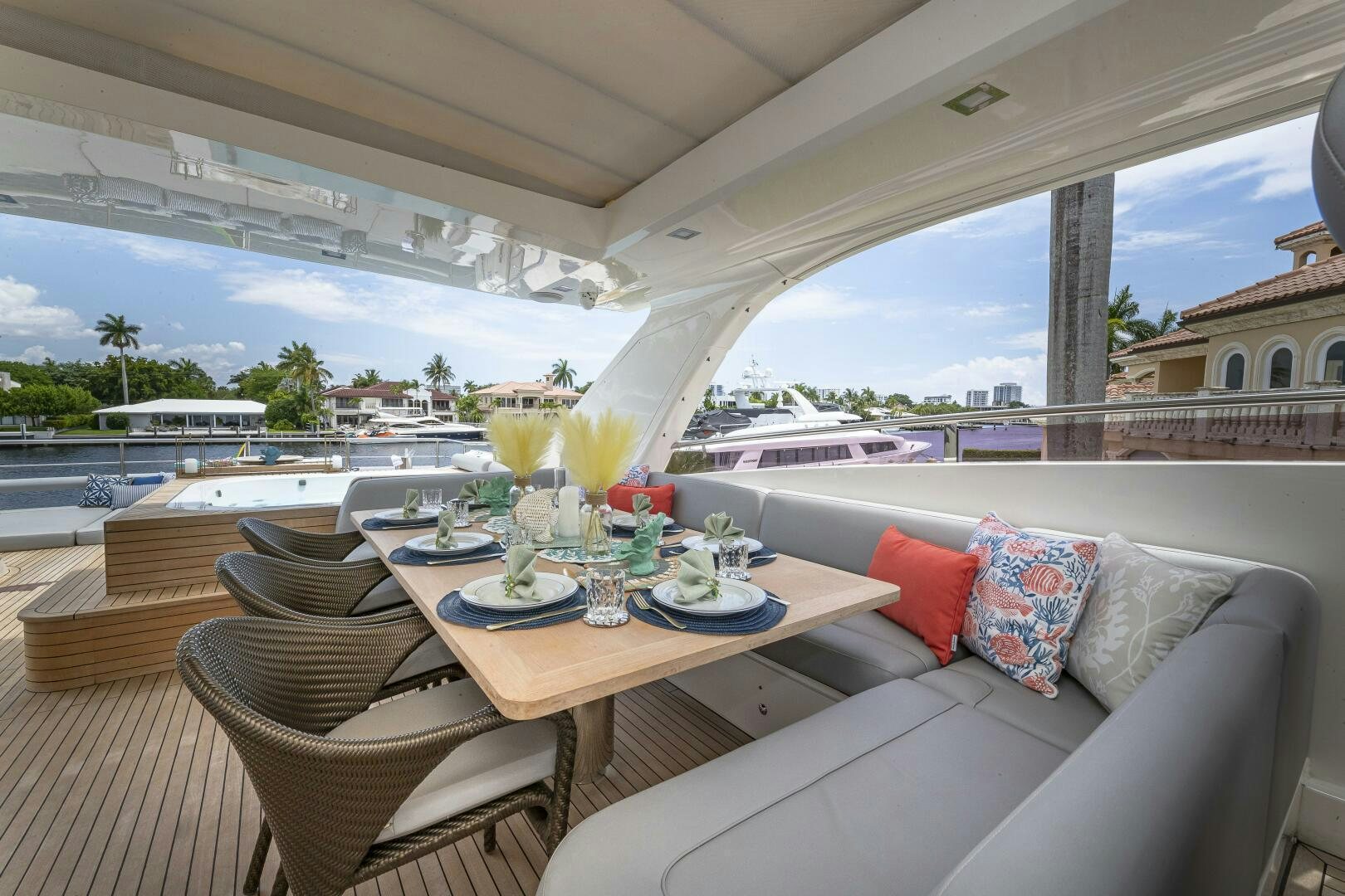 a couch and a table in a room with a view of the city aboard BEACHFRONT II Yacht for Sale