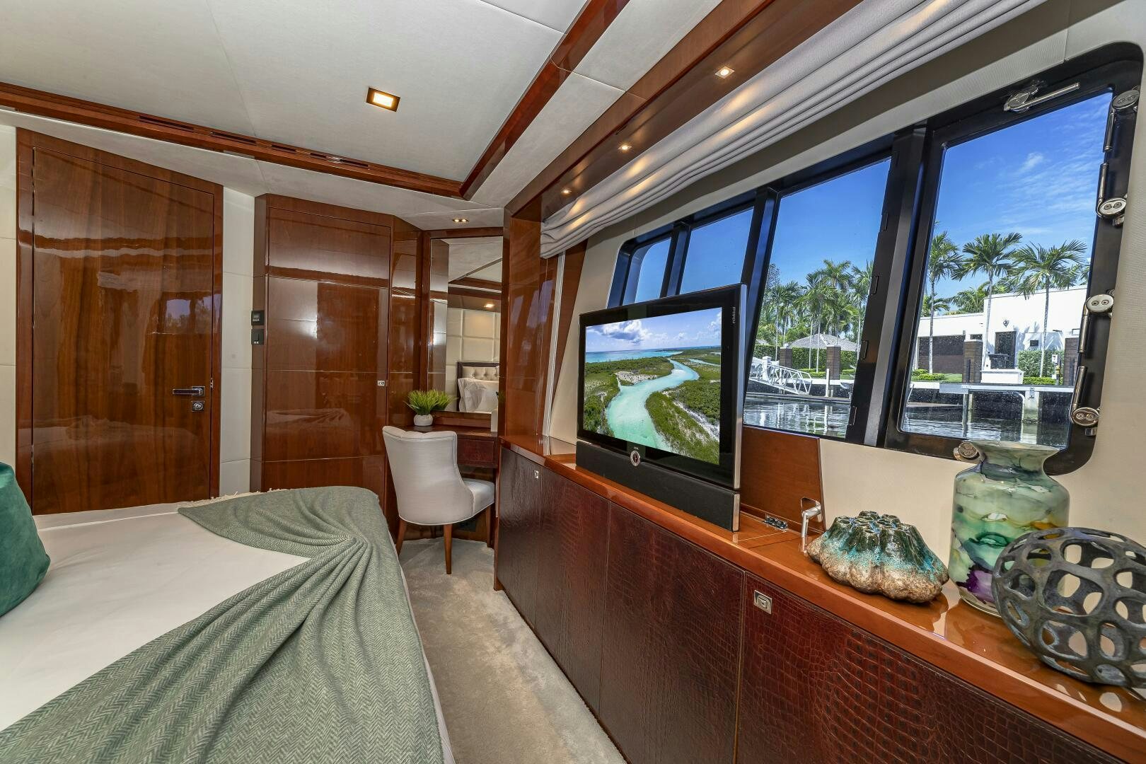 a room with a tv and a bed aboard BEACHFRONT II Yacht for Sale