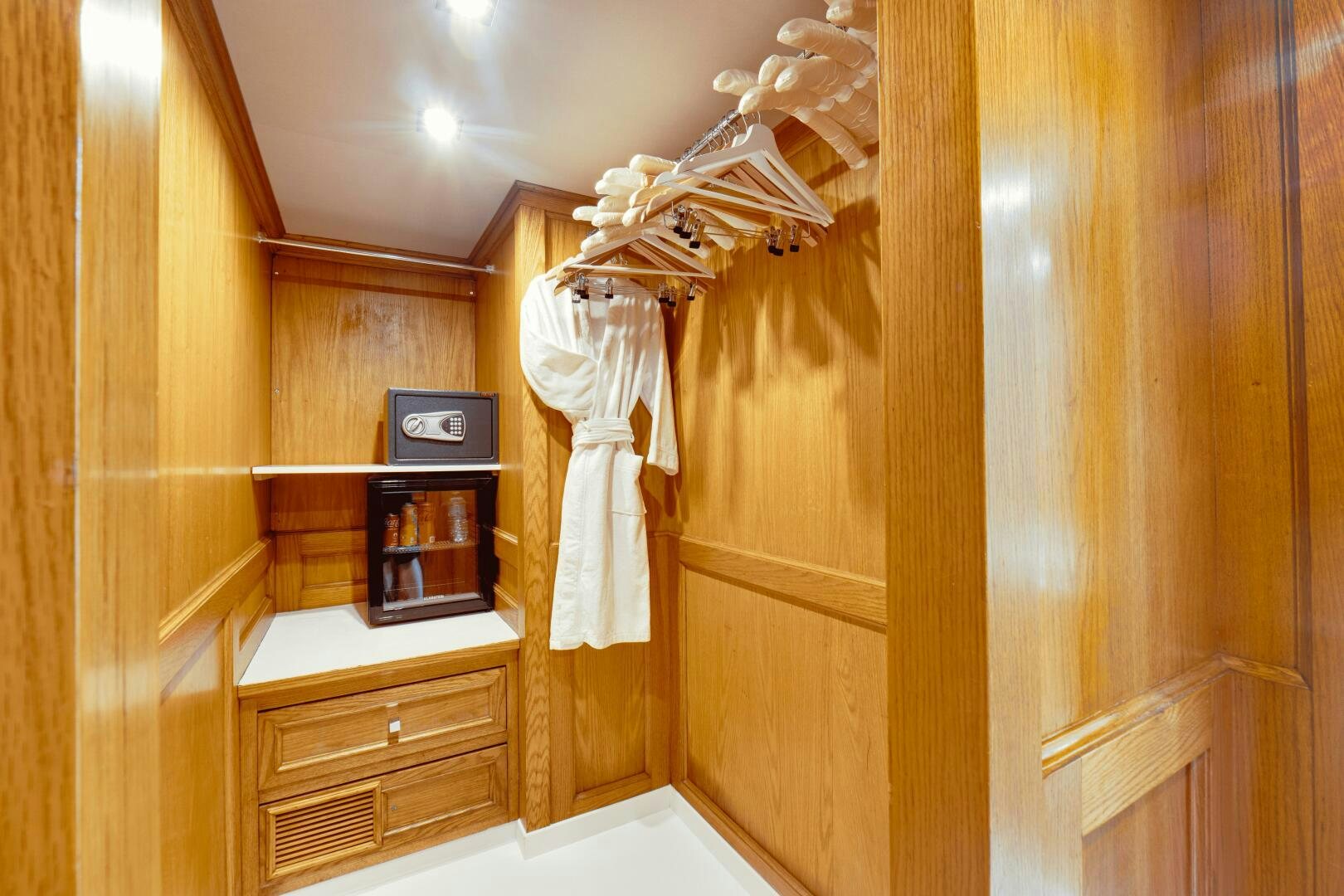 a room with a closet and a clock aboard EVA Yacht for Sale