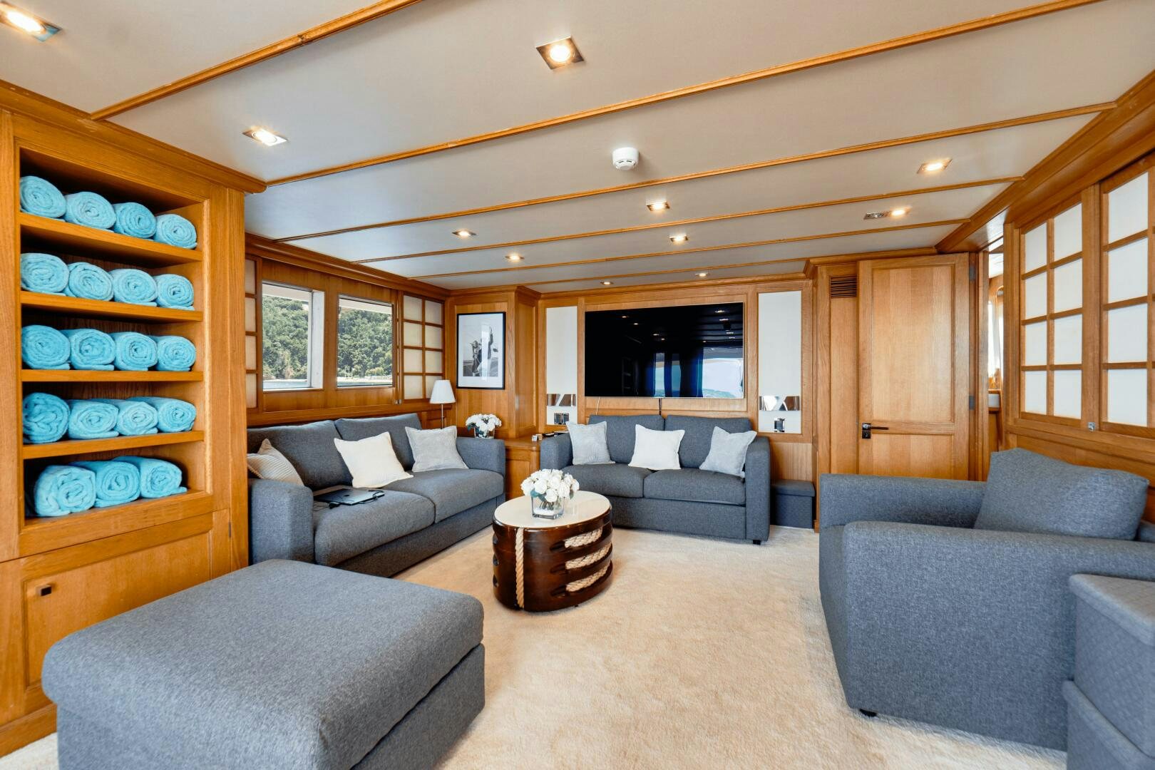 a living room with a large window aboard EVA Yacht for Sale