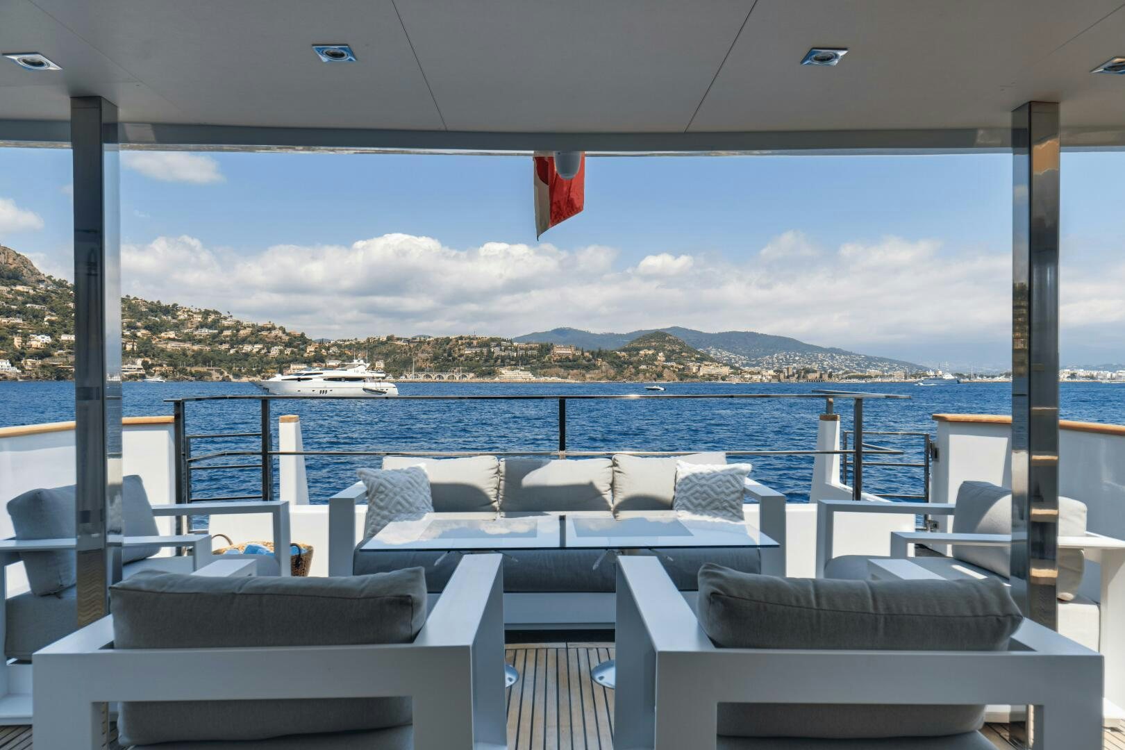 a deck with chairs and a body of water in the background aboard EVA Yacht for Sale