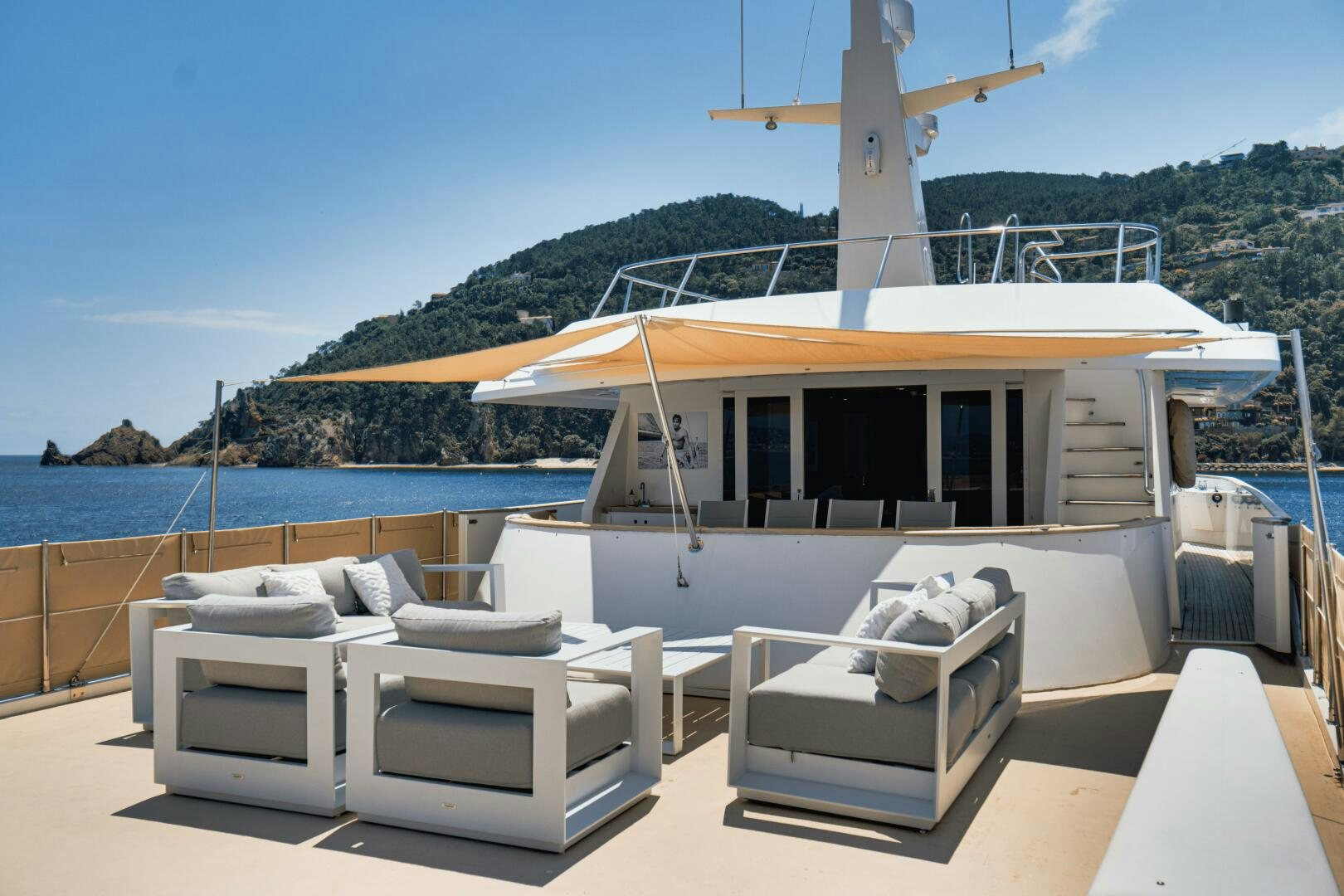 a white lounge chair on a beach aboard EVA Yacht for Sale
