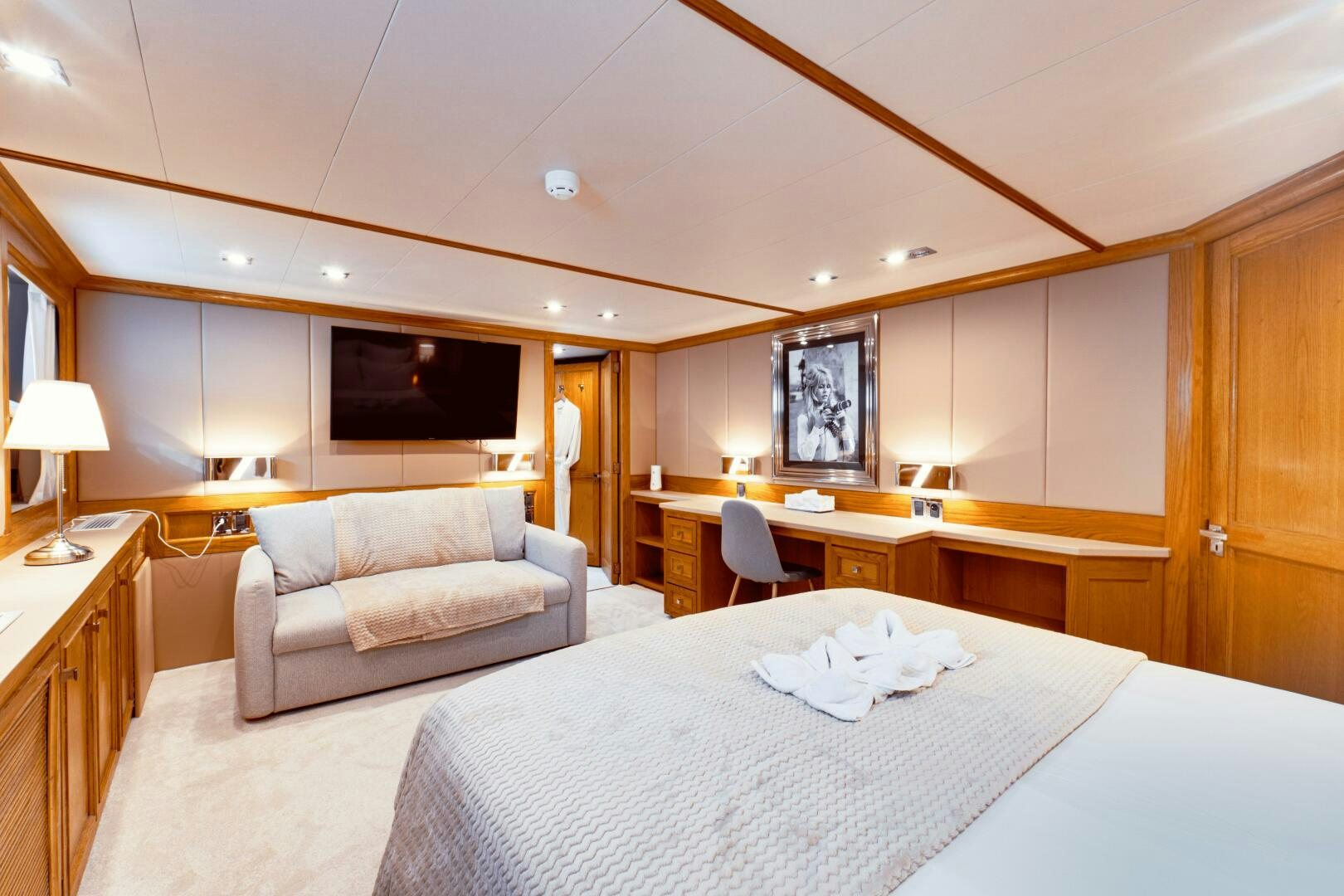 a hotel room with a bed and a couch aboard EVA Yacht for Sale