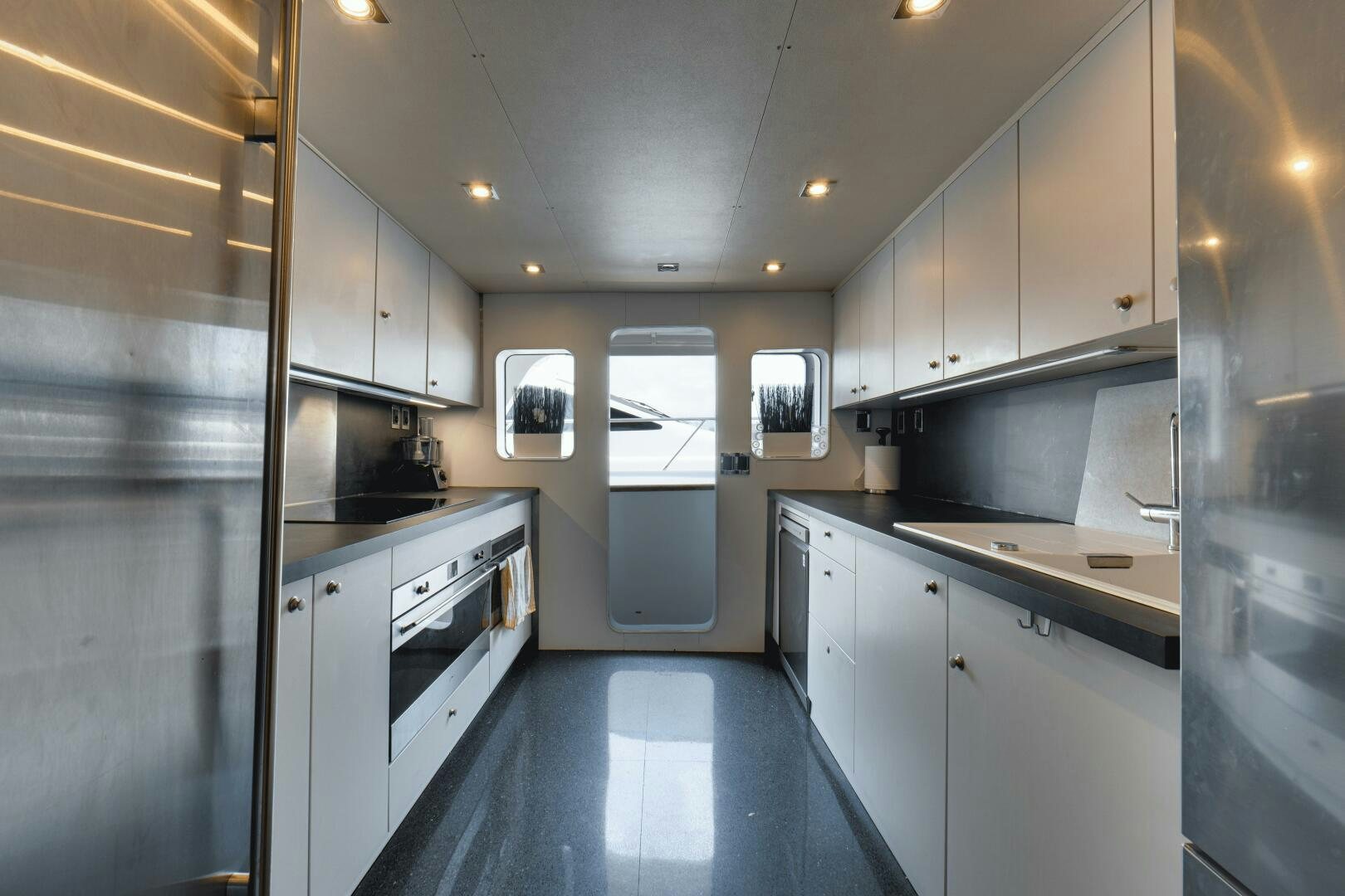 a kitchen with white cabinets aboard EVA Yacht for Sale