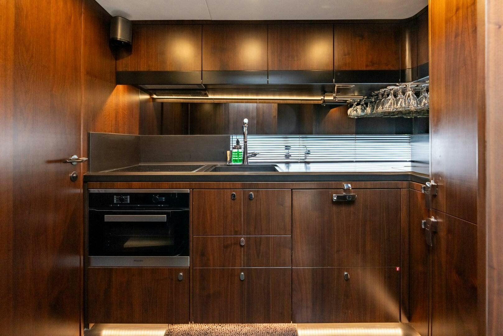 a kitchen with wooden cabinets aboard NOROADER Yacht for Sale