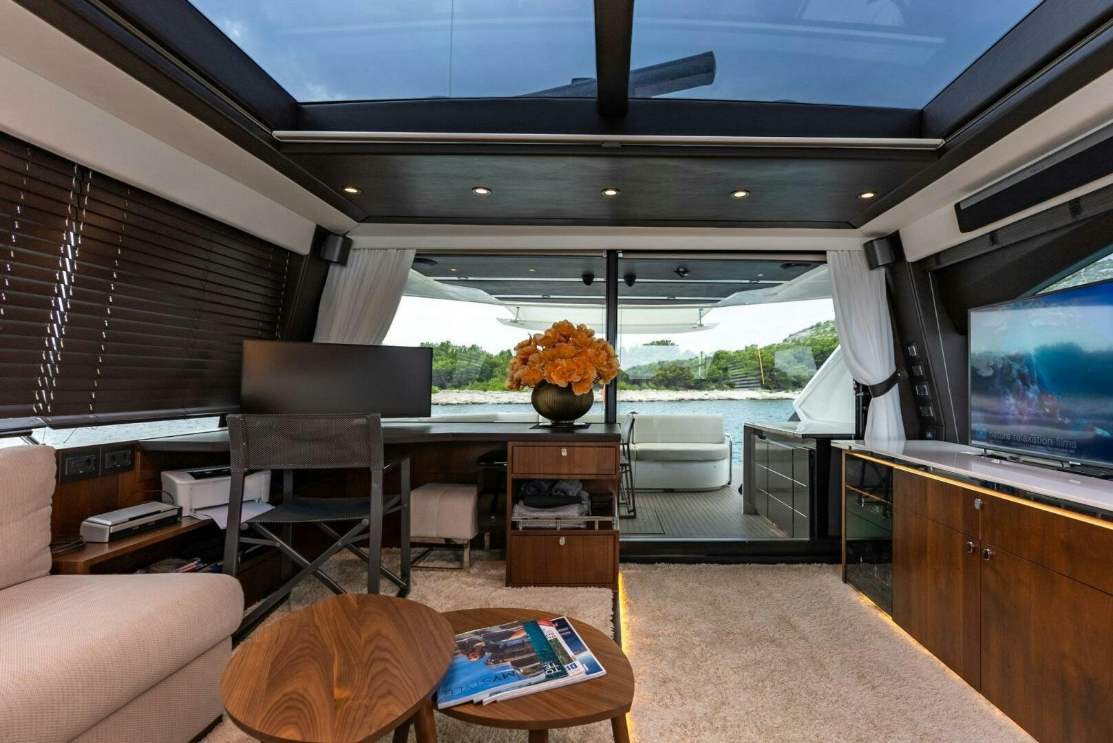 a living room with a large window aboard NOROADER Yacht for Sale