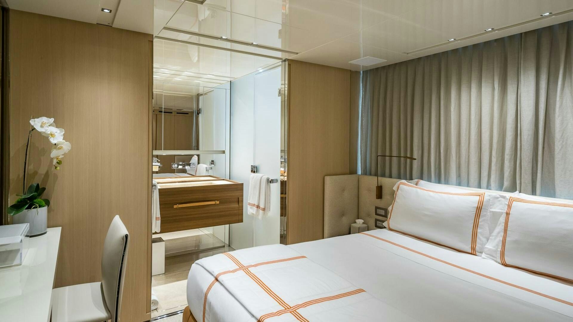 a hotel room with a bed and a mirror aboard WOMBAT Yacht for Sale