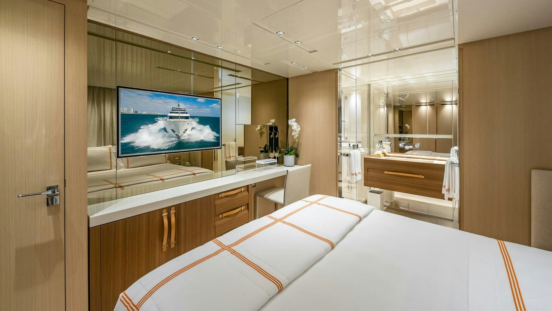 a hotel room with a bed and a tv aboard WOMBAT Yacht for Sale