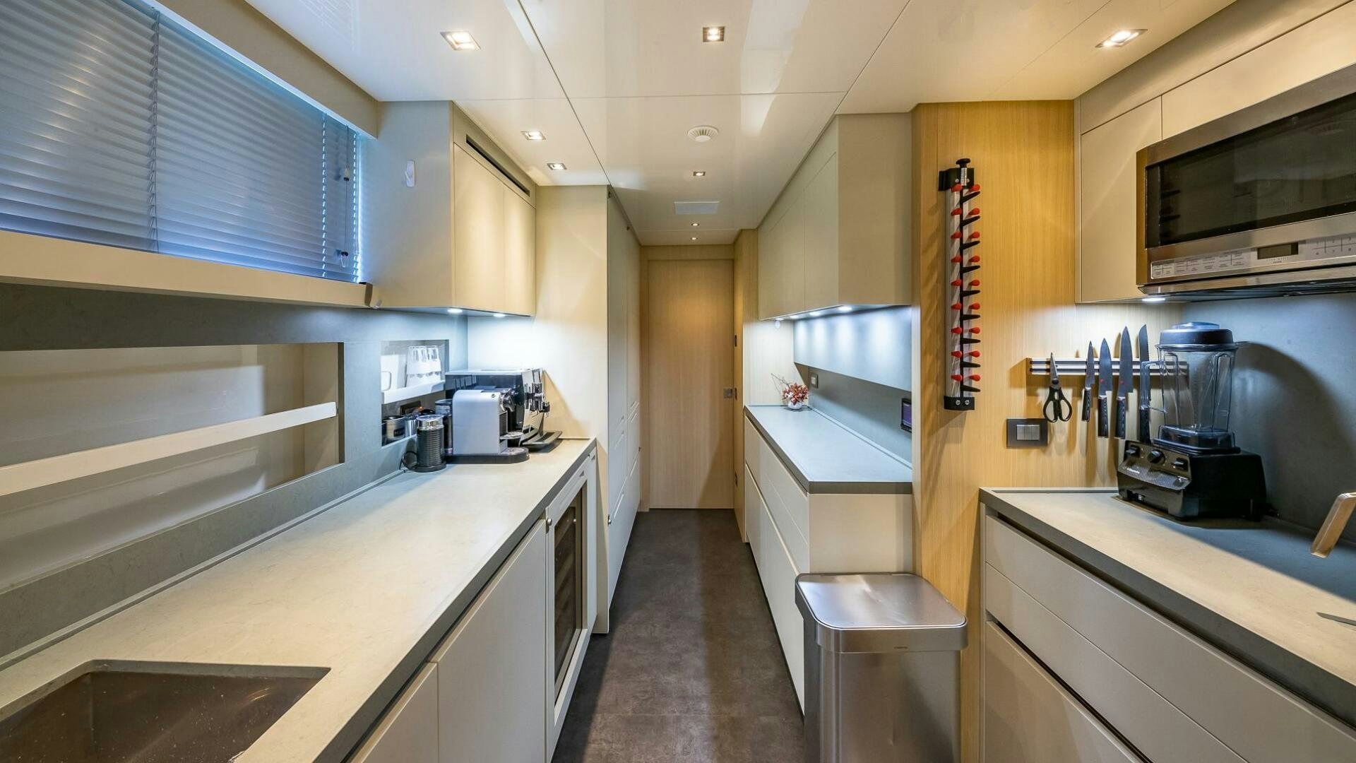 a kitchen with white cabinets aboard WOMBAT Yacht for Sale