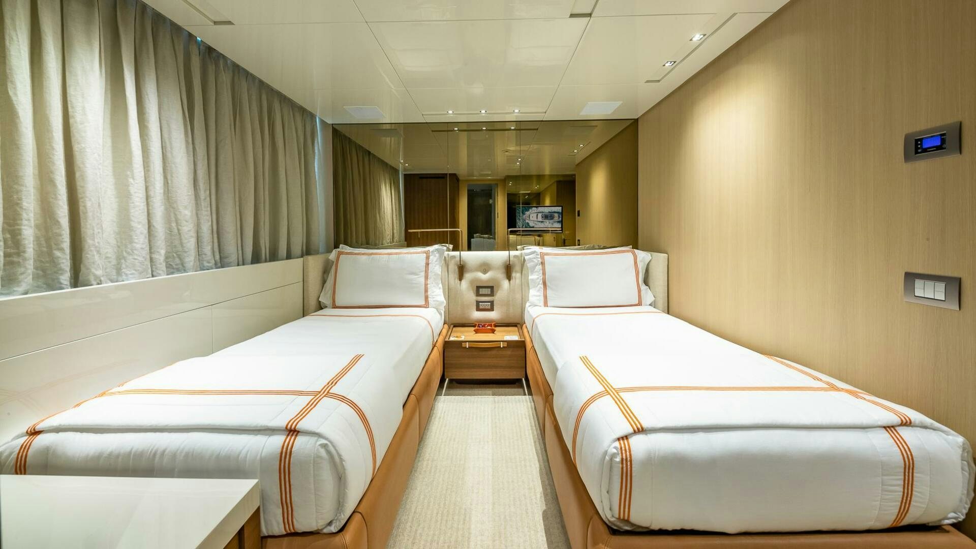 a room with beds and a window aboard WOMBAT Yacht for Sale
