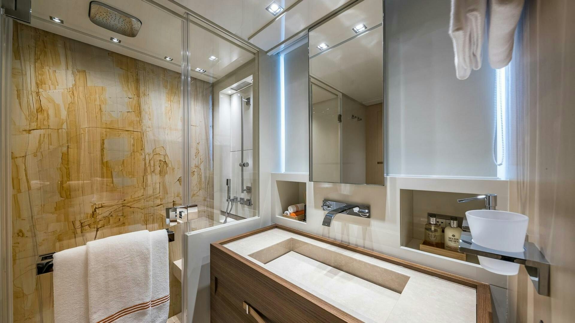 a bathroom with a large mirror aboard WOMBAT Yacht for Sale