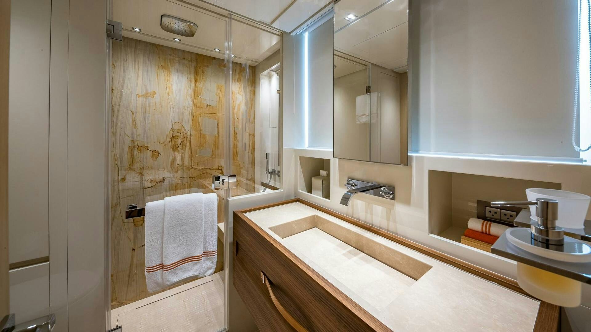 a bathroom with a shower and sink aboard WOMBAT Yacht for Sale