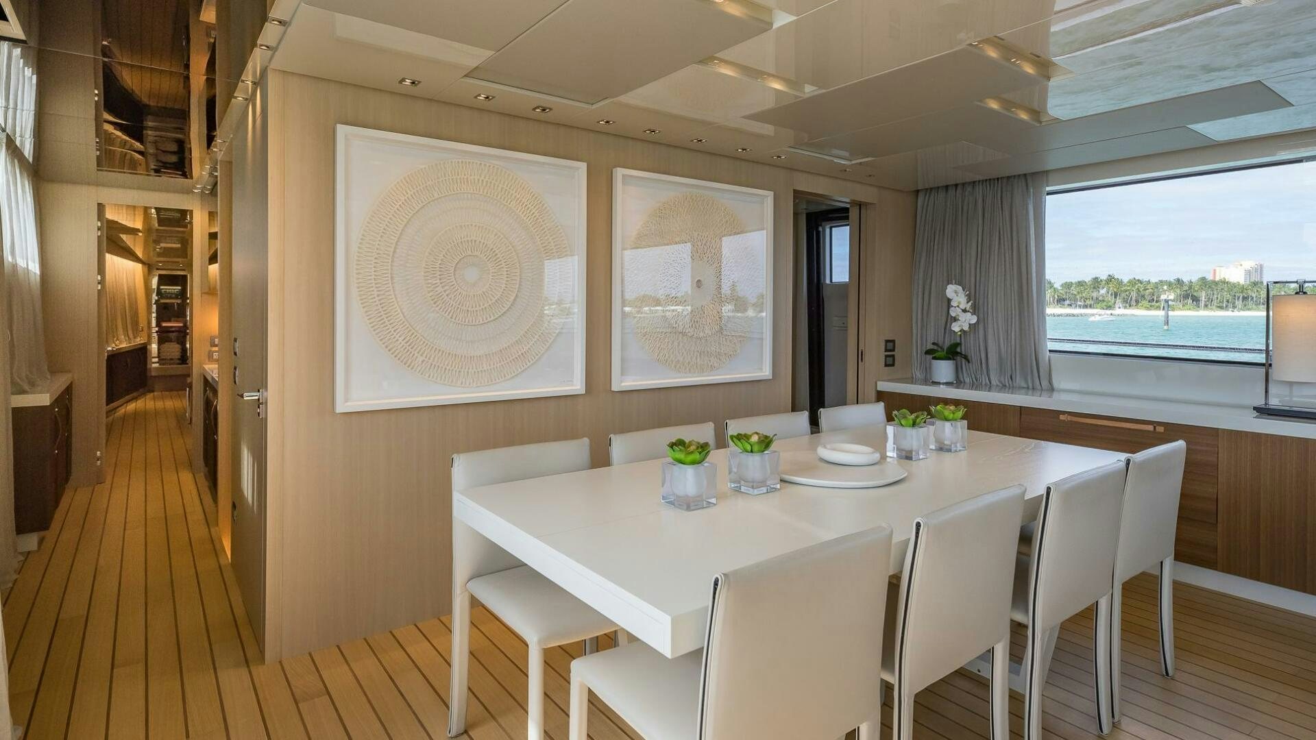 a table with chairs and a white table with white chairs aboard WOMBAT Yacht for Sale