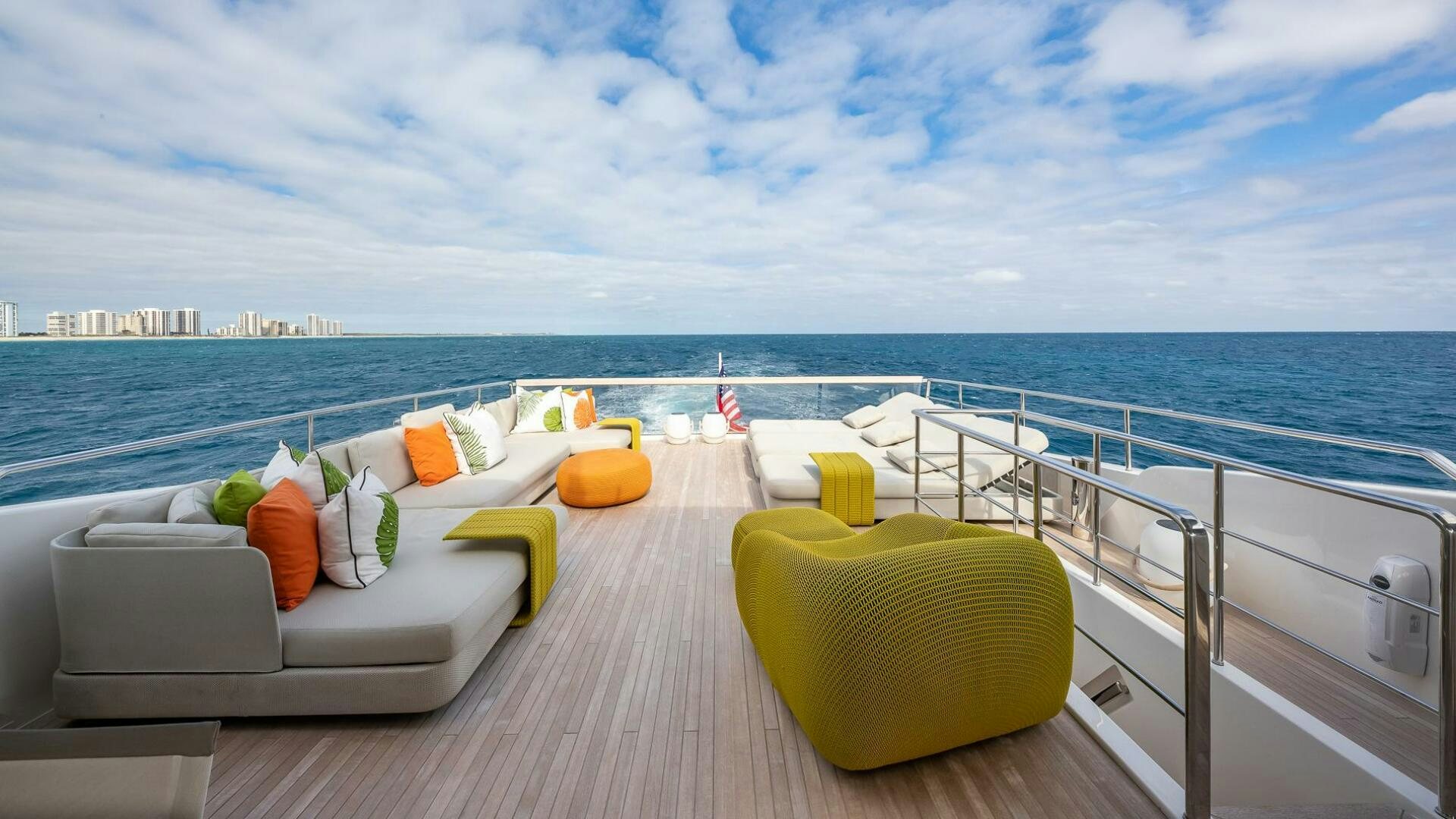 a deck with chairs and a large body of water aboard WOMBAT Yacht for Sale