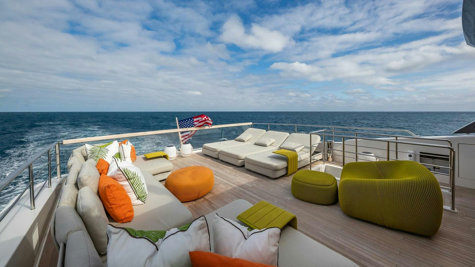 a deck with a beach and chairs aboard WOMBAT Yacht for Sale