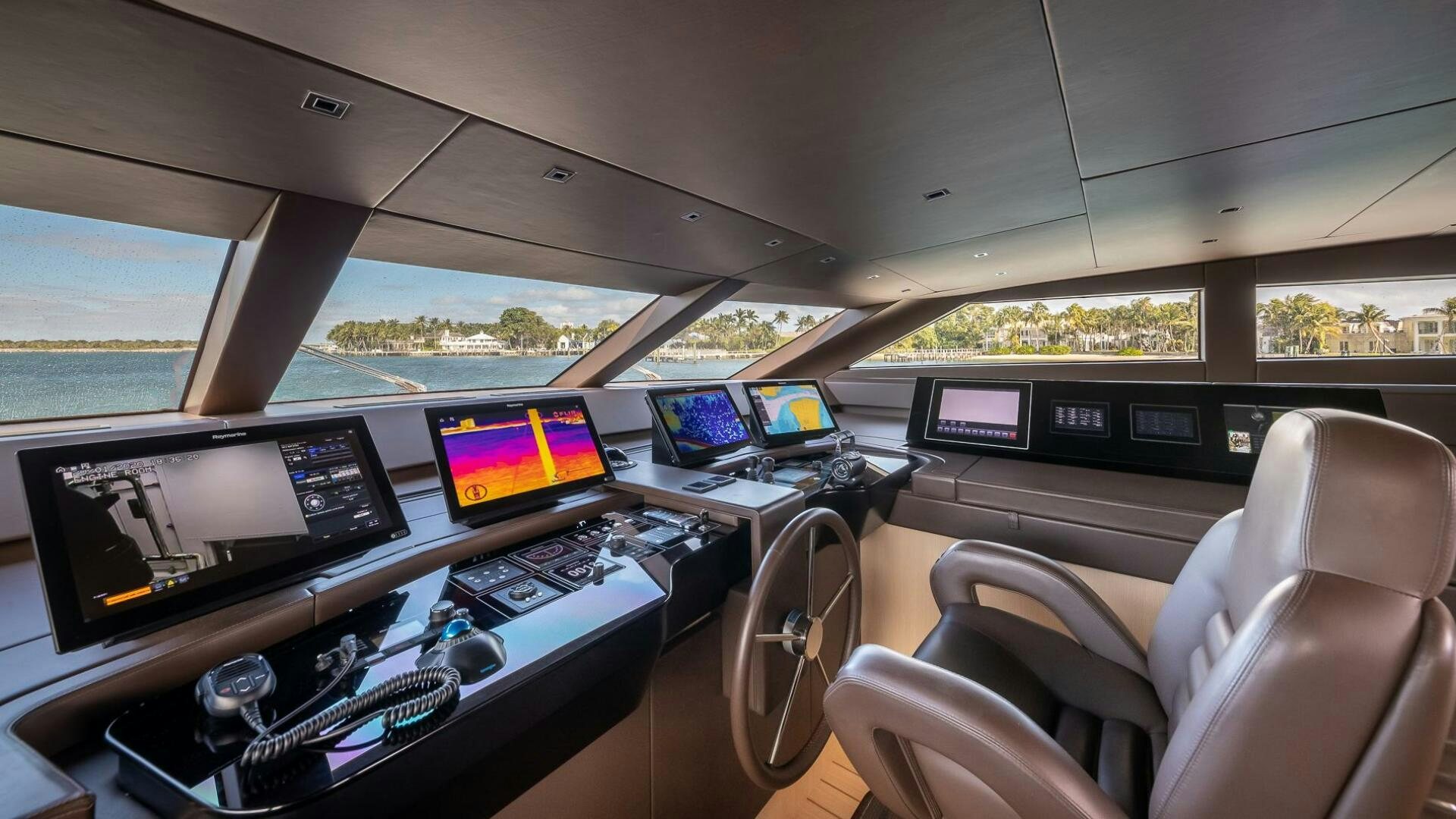 inside of a car with many monitors and screens aboard WOMBAT Yacht for Sale