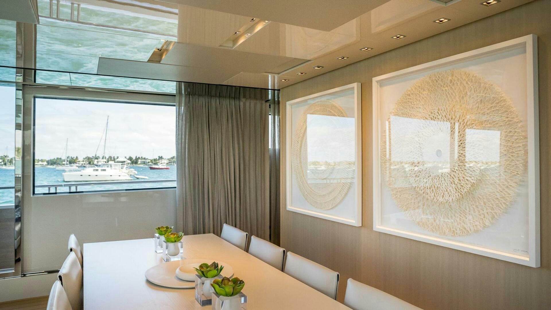 a room with a table and chairs aboard WOMBAT Yacht for Sale