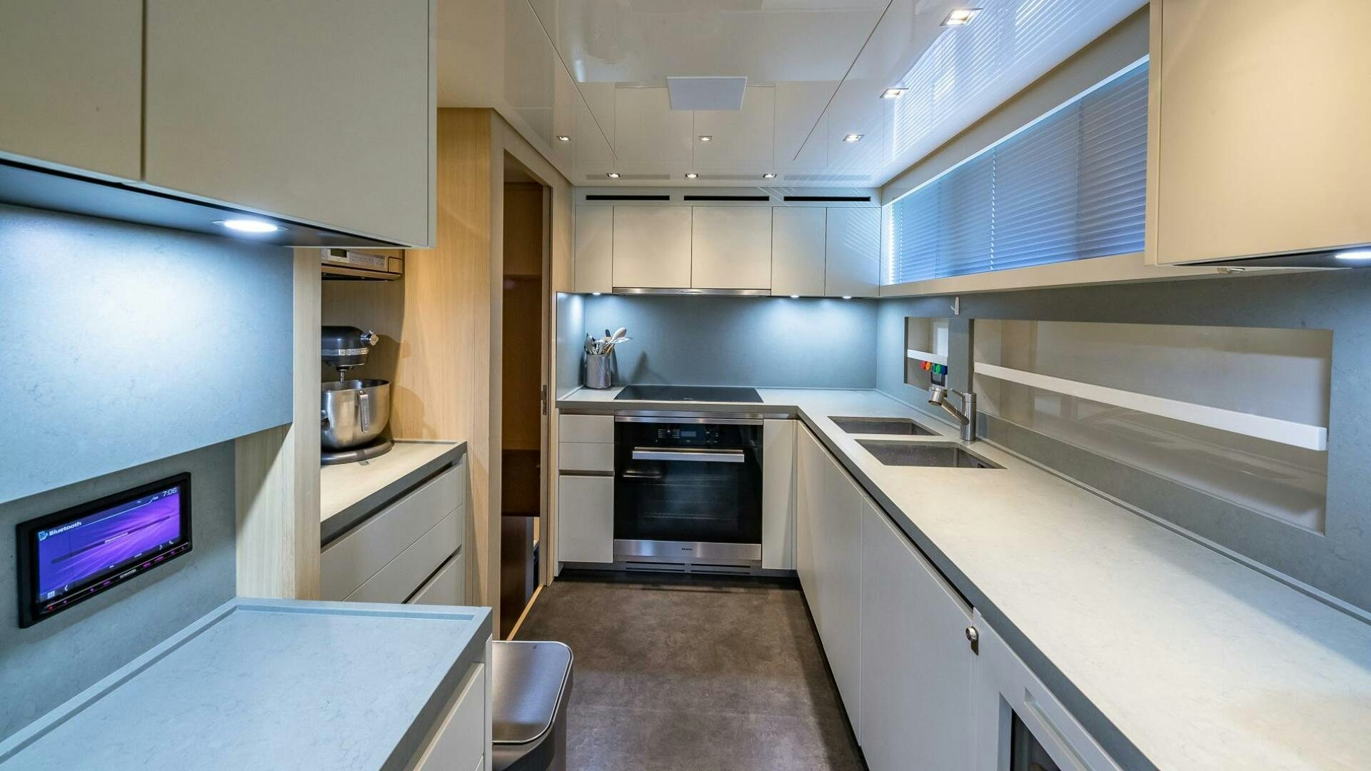 a kitchen with white cabinets aboard WOMBAT Yacht for Sale