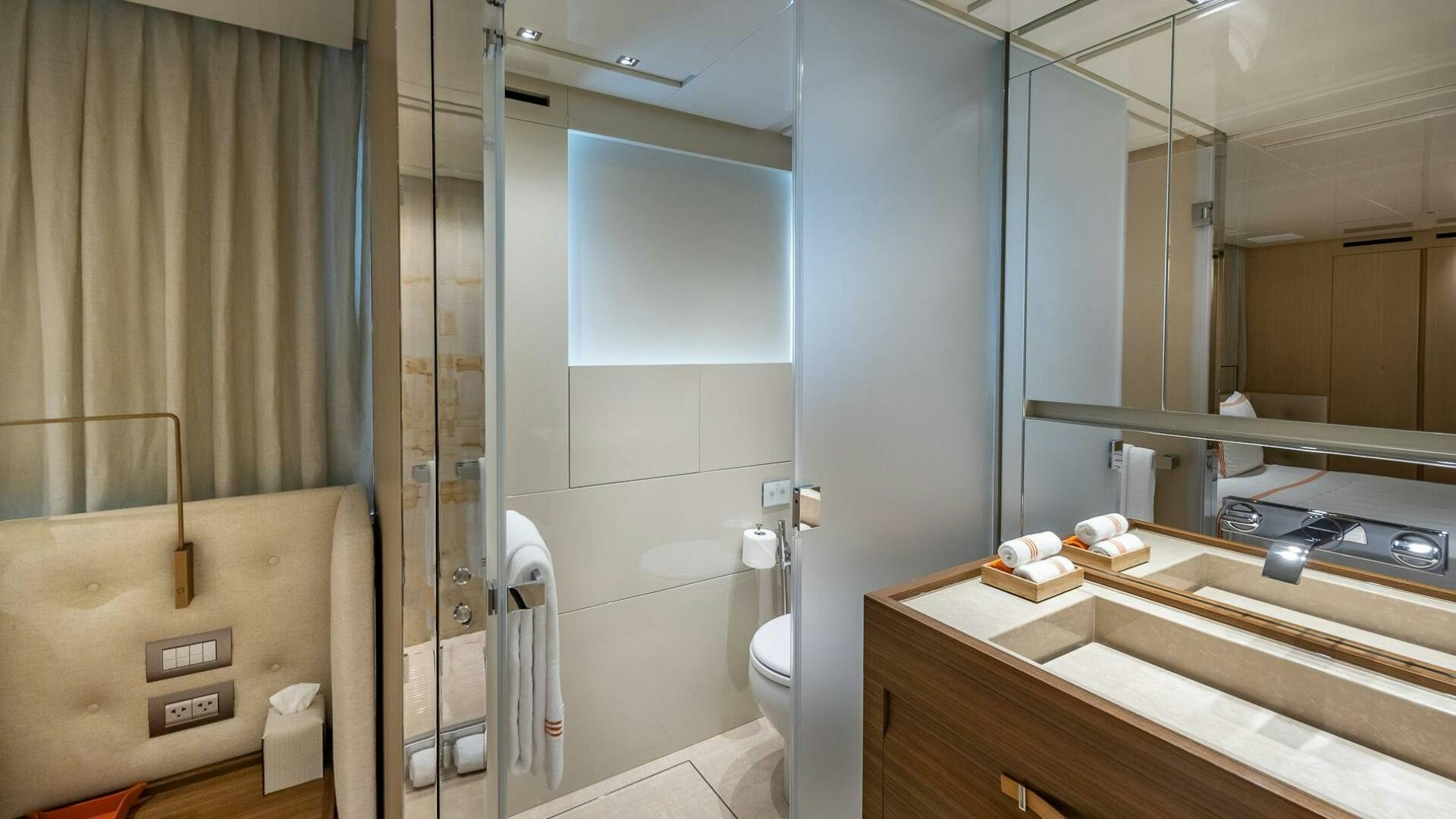 a bathroom with a glass shower aboard WOMBAT Yacht for Sale