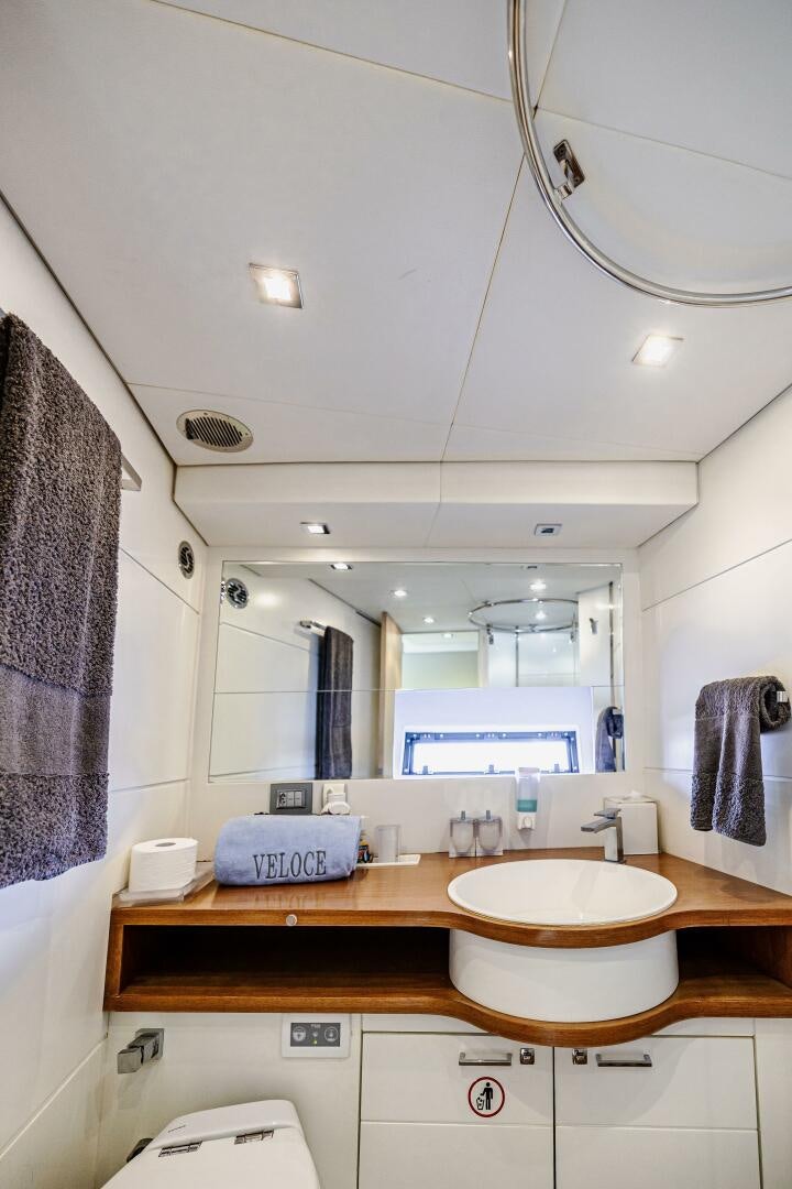 a bathroom with a large mirror aboard VELOCE II Yacht for Sale
