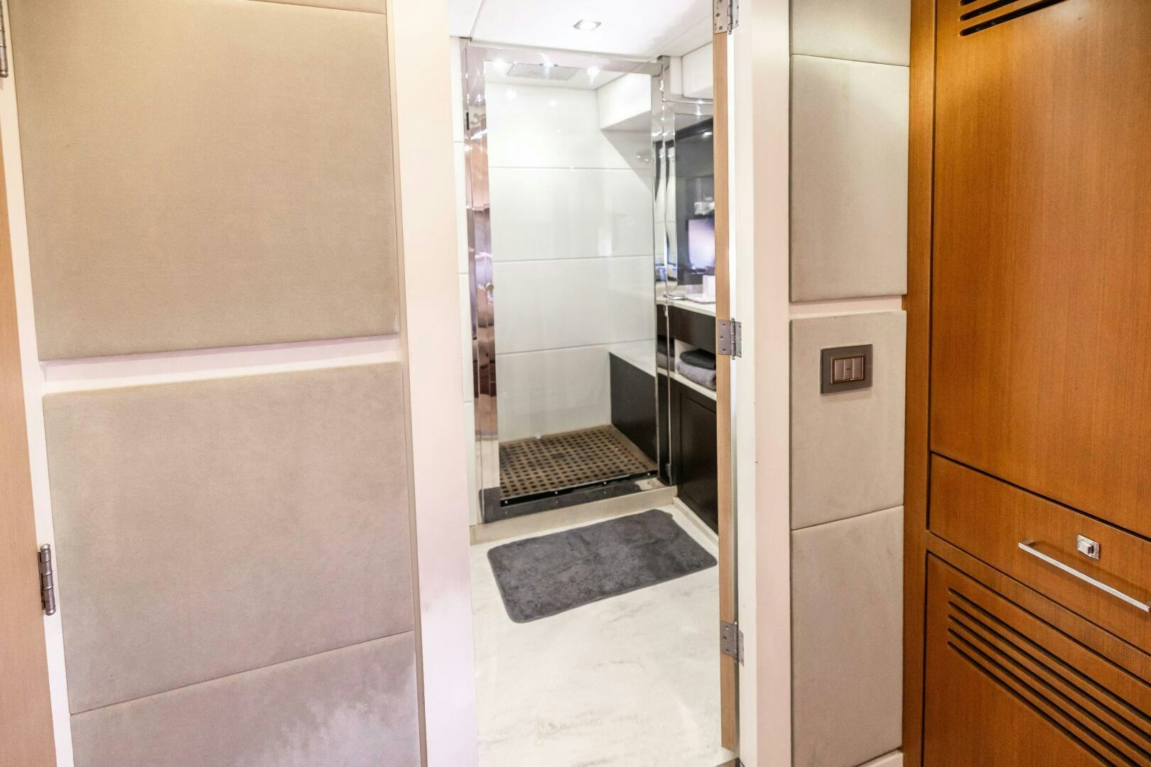 a hallway with a door and a glass door aboard VELOCE II Yacht for Sale