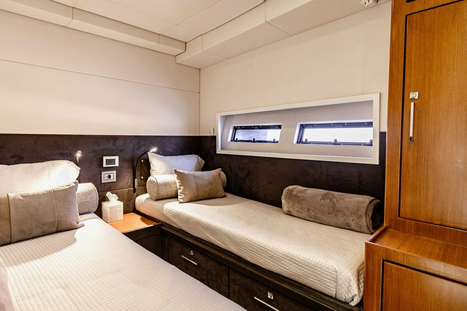 a bedroom with a bed and a tv on the wall aboard VELOCE II Yacht for Sale