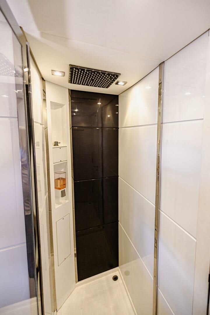 a bathroom with a black shower unit aboard VELOCE II Yacht for Sale