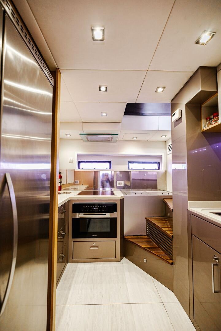 a kitchen with a sliding glass door aboard VELOCE II Yacht for Sale