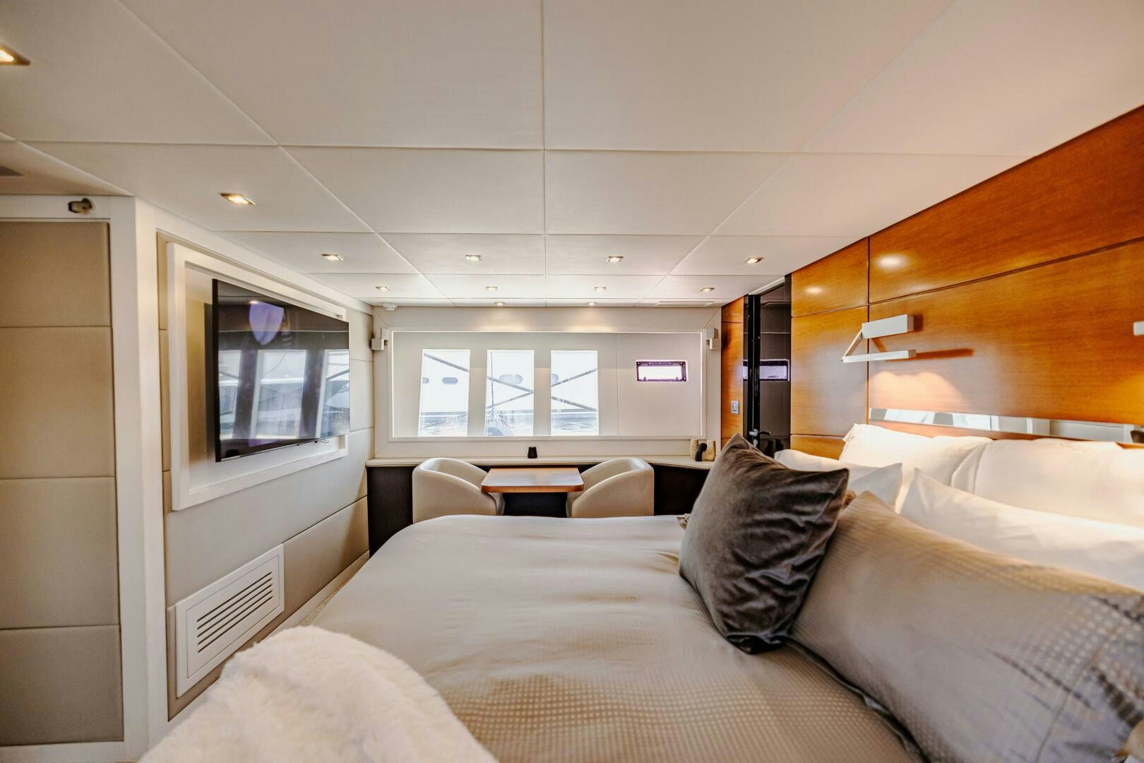 a bedroom with a bed and a window aboard VELOCE II Yacht for Sale