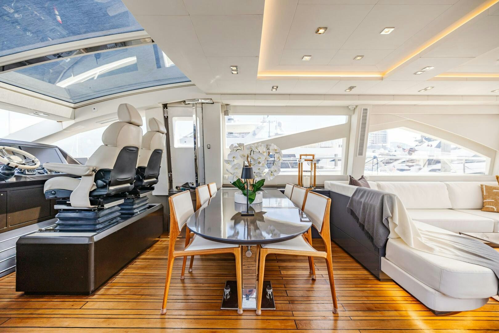 a room with a table and chairs aboard VELOCE II Yacht for Sale