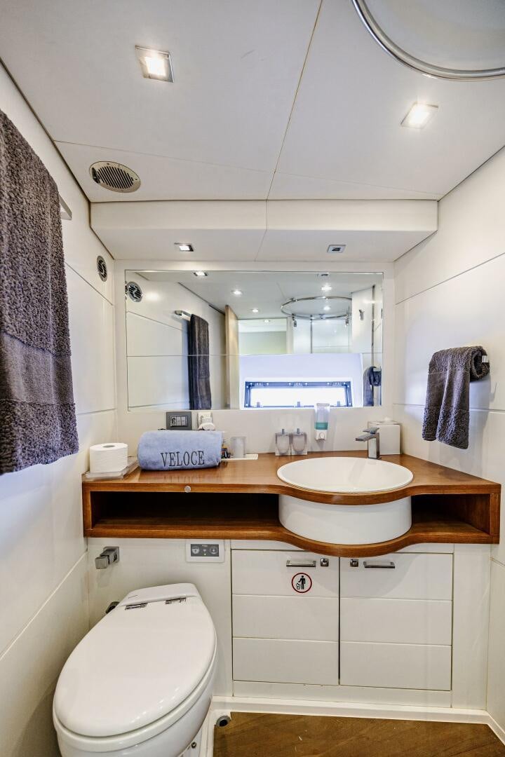 a bathroom with a sink and a mirror aboard VELOCE II Yacht for Sale