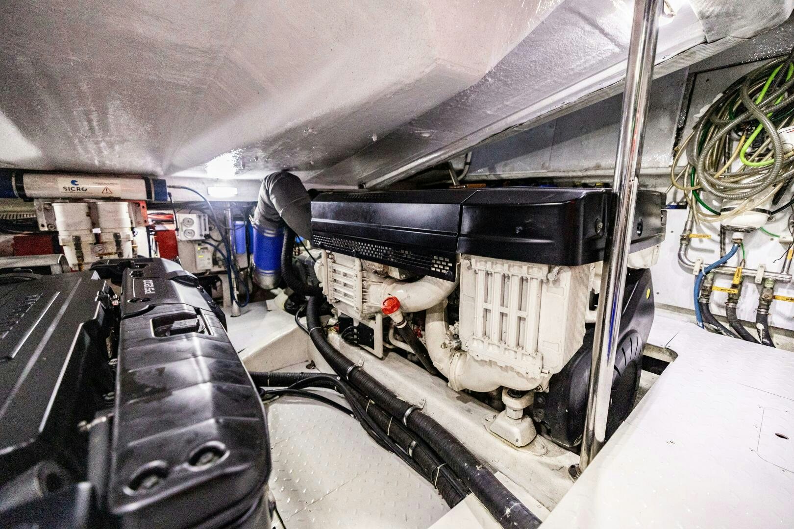 a car with a large engine aboard VELOCE II Yacht for Sale